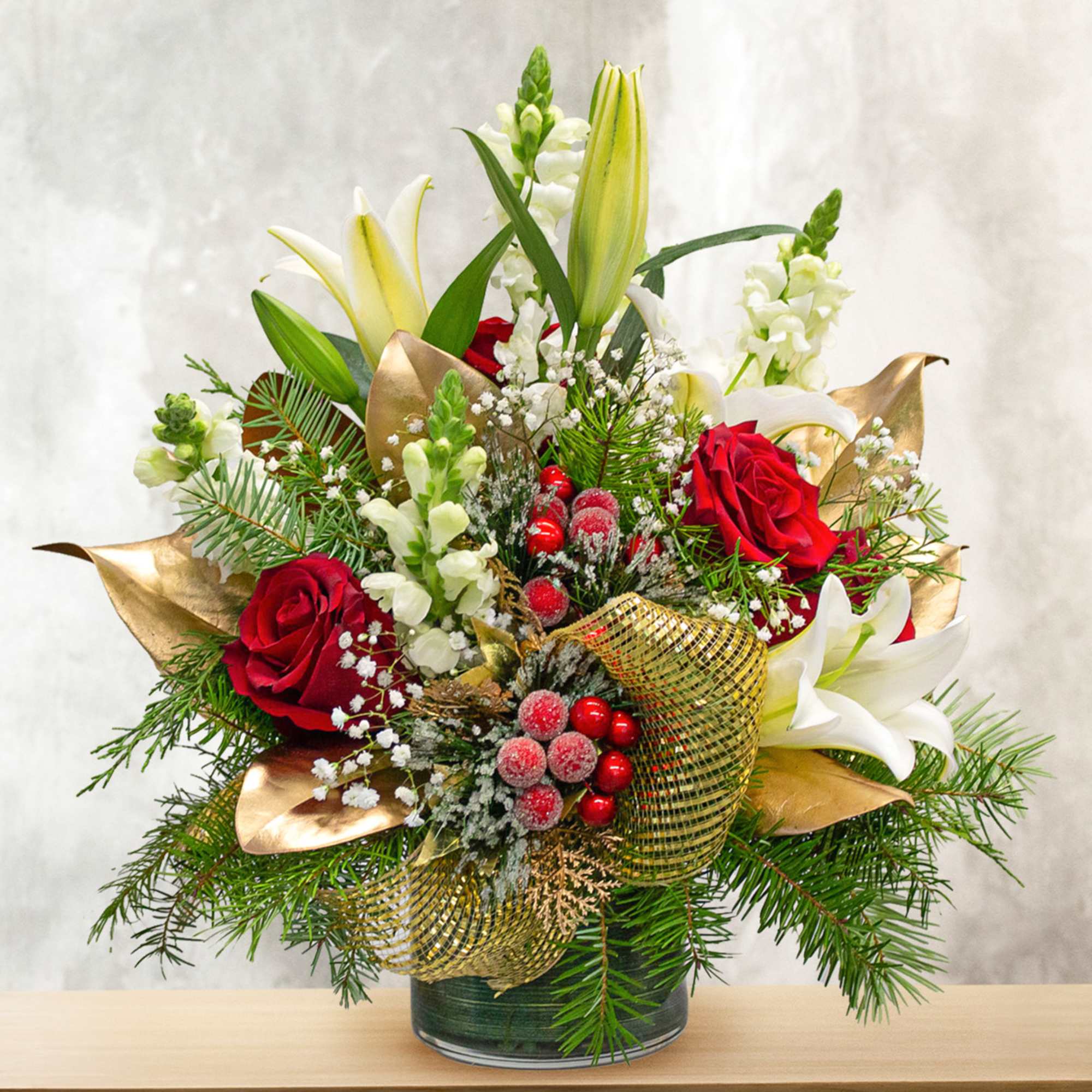 This unique holiday design includes lilies, roses, snapdragon, magnolia leaves and holiday