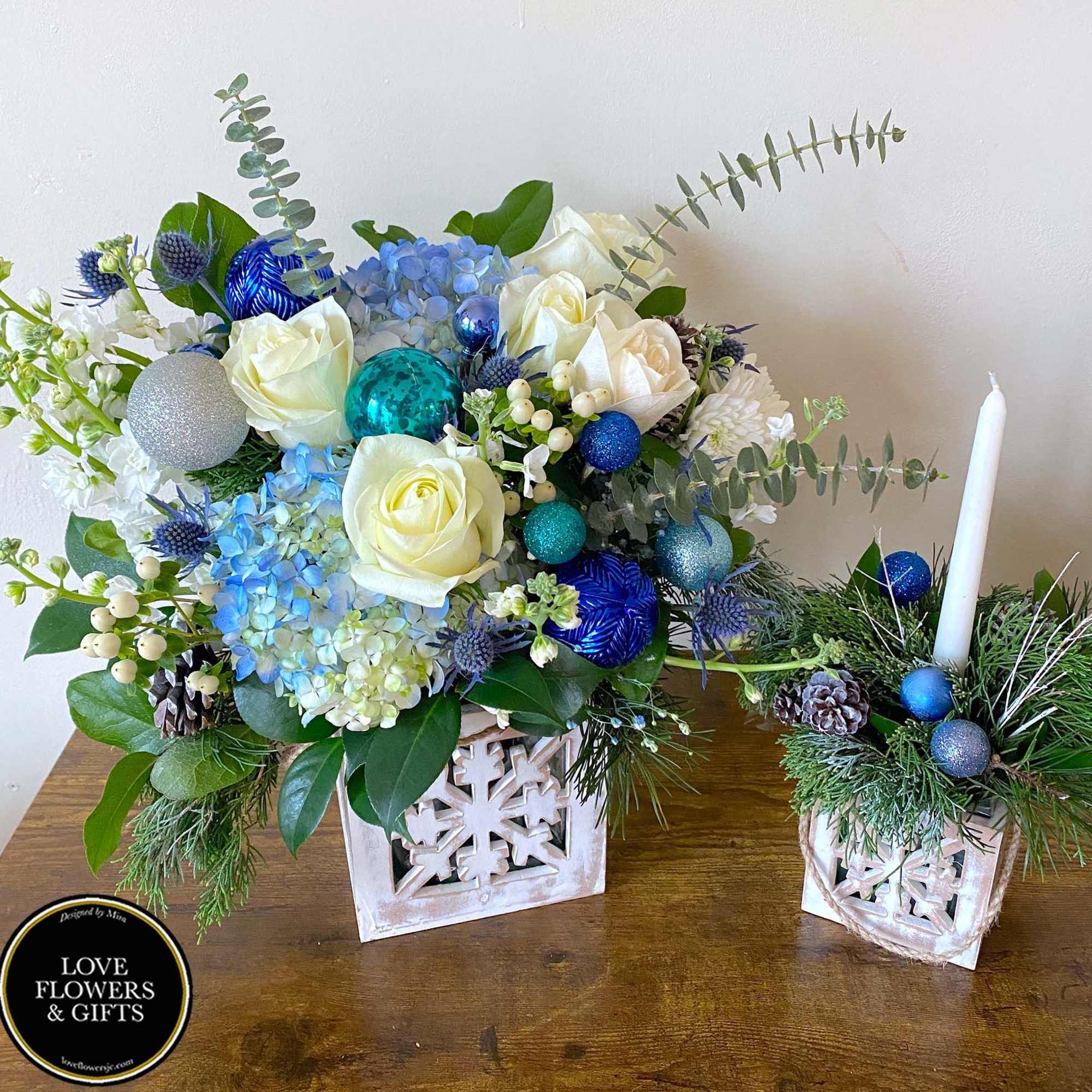 A unique holiday arrangement, designed in a beautiful wooden snowflake box. Made