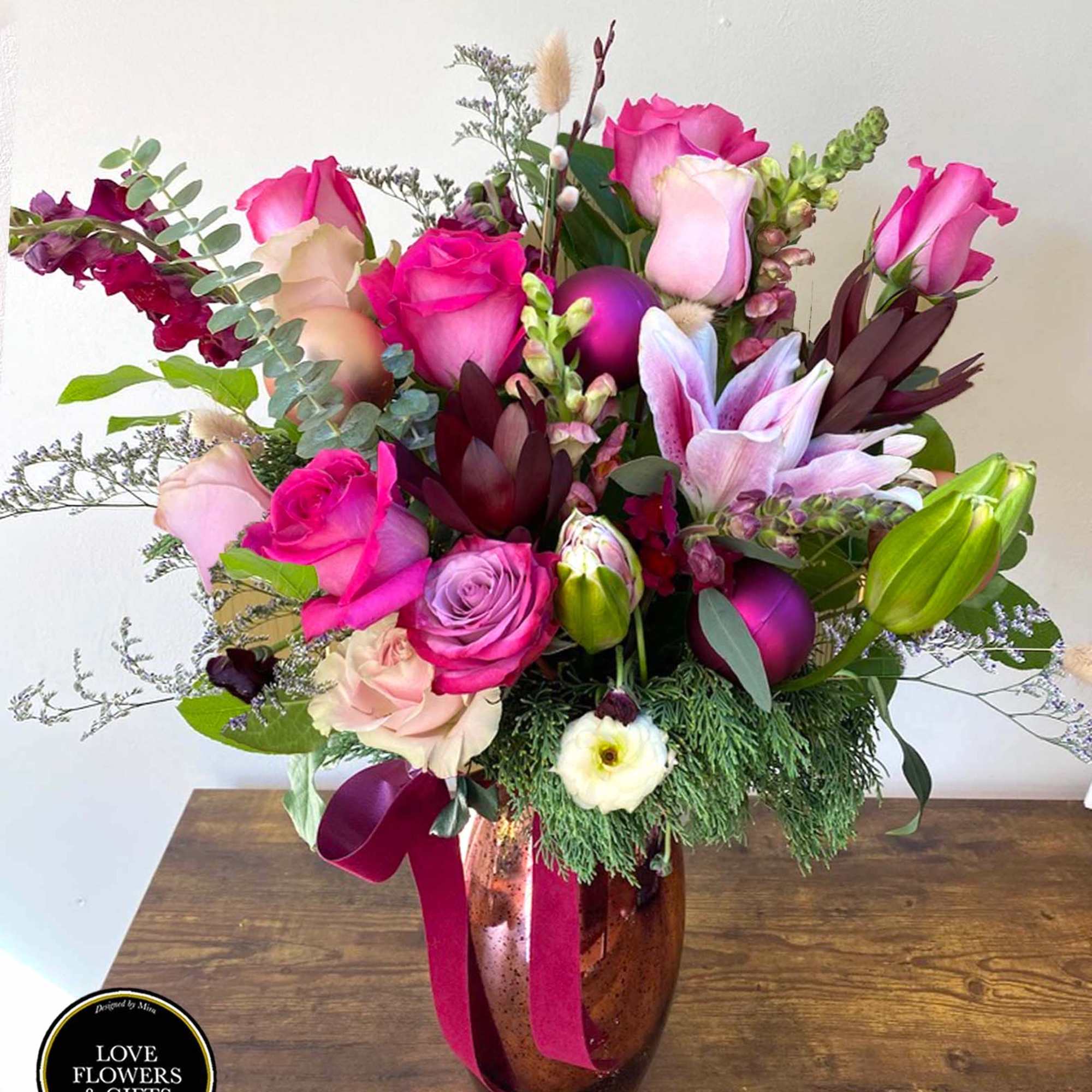 Modern and Stylish holiday arrangement, designed in a beautiful tall rose gold