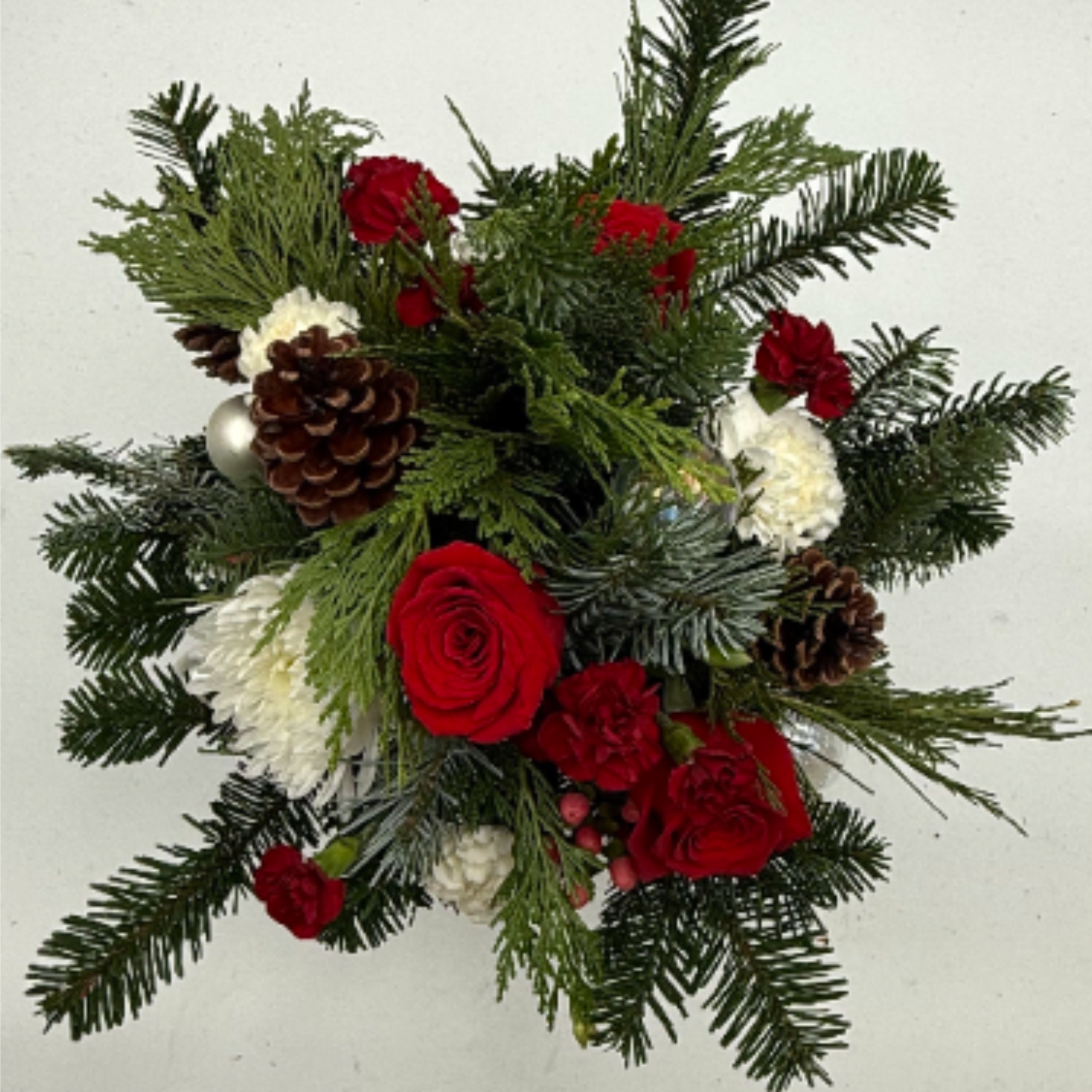 This arrangement is in a holiday keepsake metal pot, filled with Red