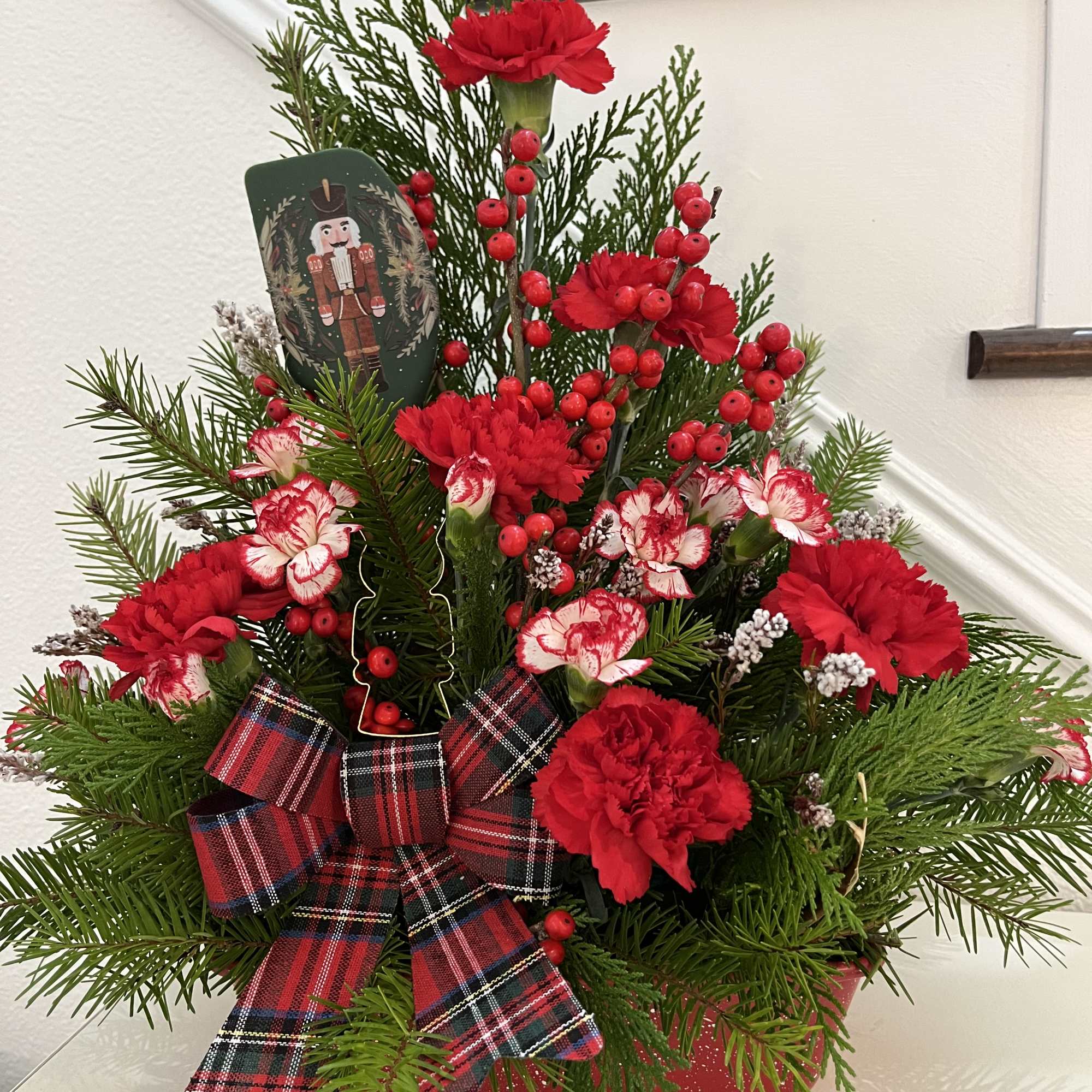 Bouquet of carnations, Christmas greens, with a cute spatula, loaf pan and