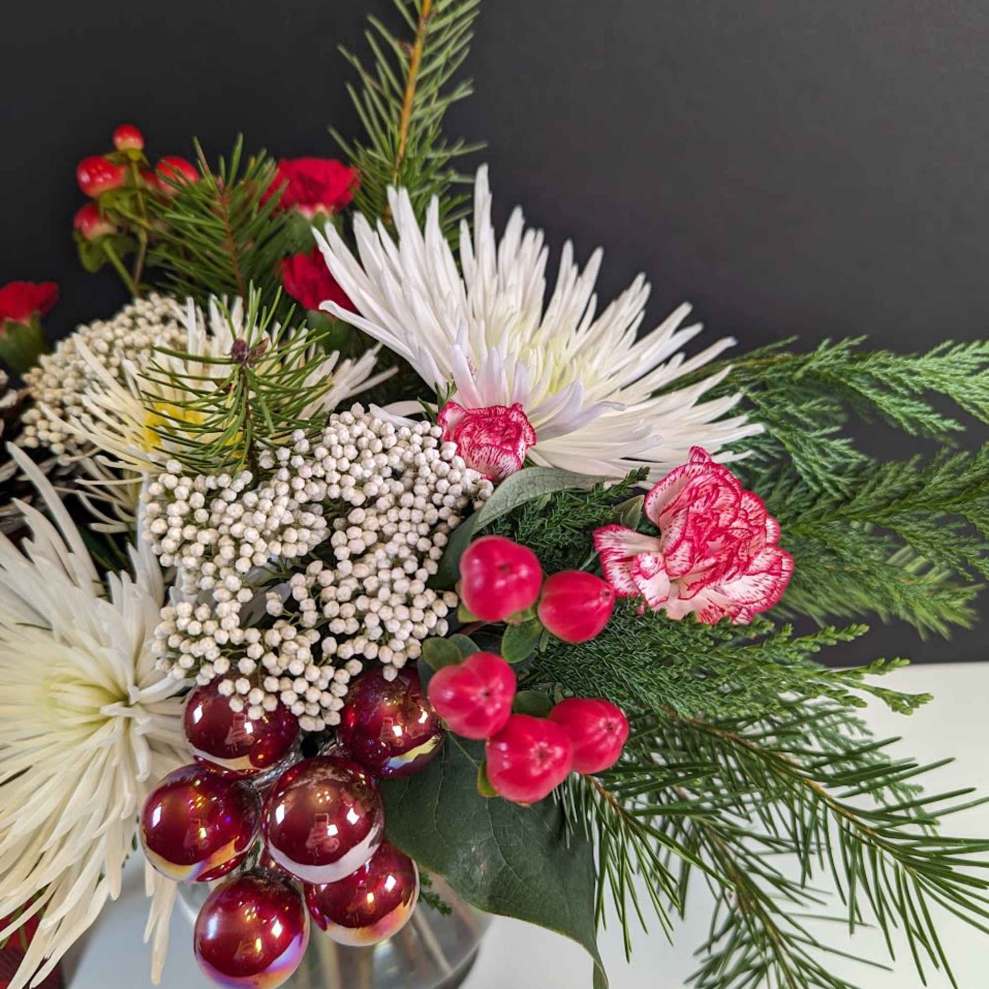 Celebrate the season in style with our Holly Jolly Blooms arrangement. This