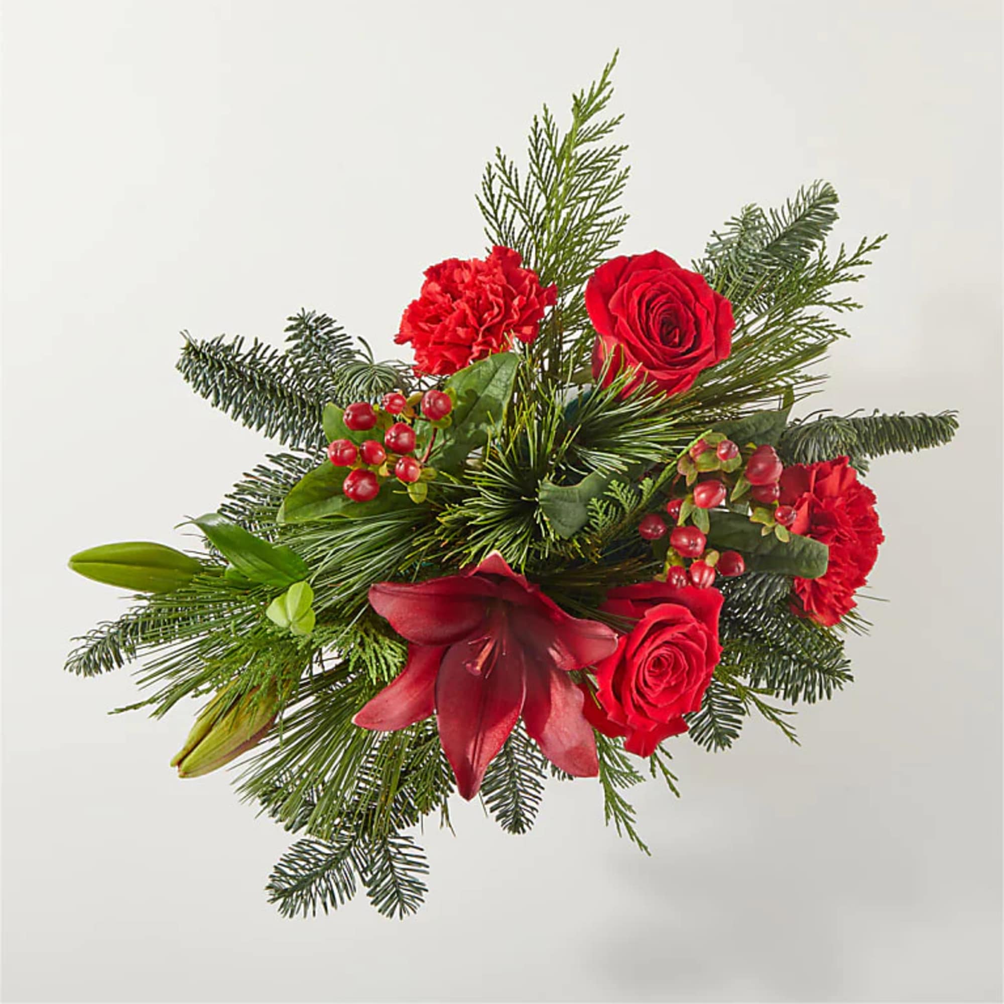 Deck their halls with this lively bouquet studded with eye catching red