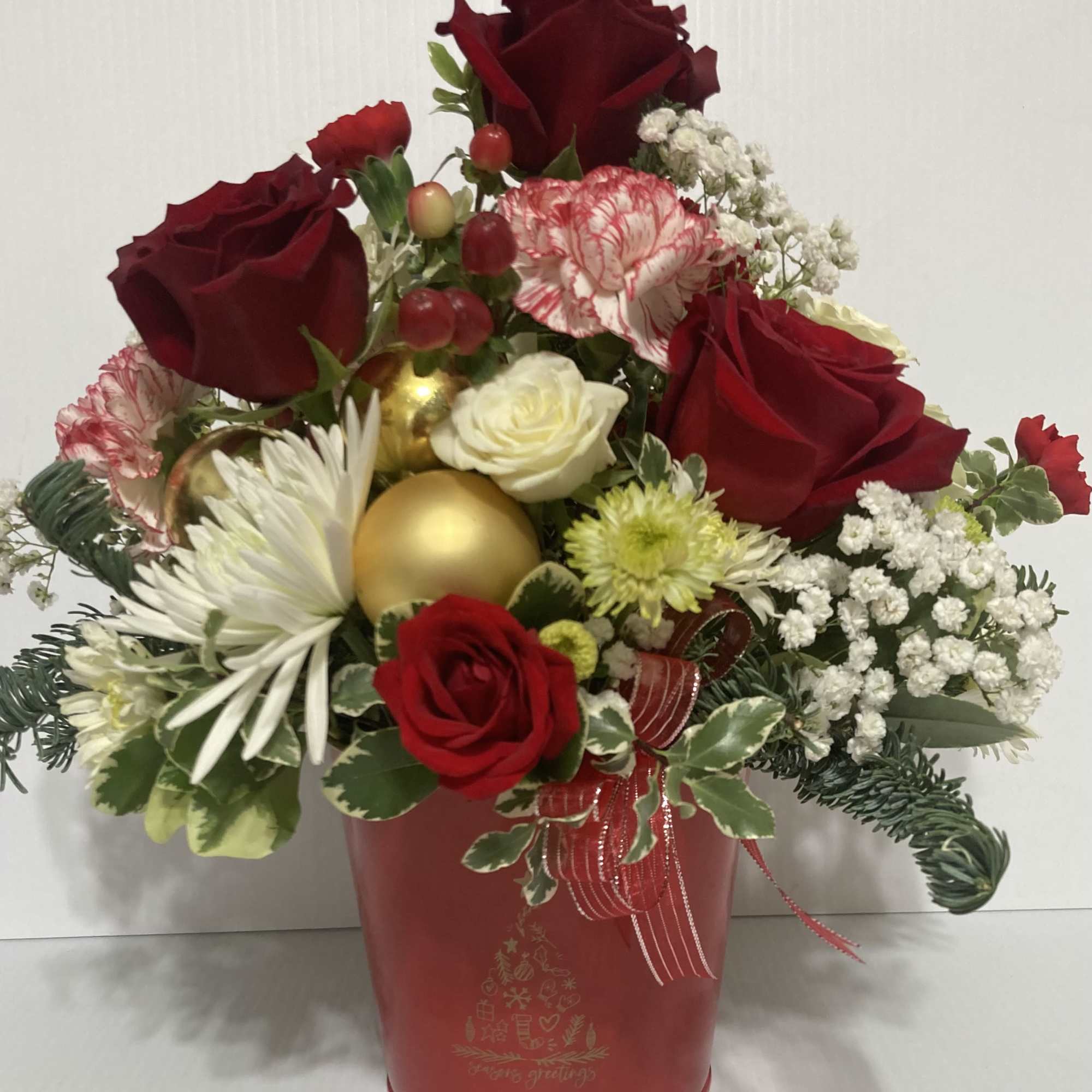 Holiday arrangement in a cute red metal pot with Christmas tree on