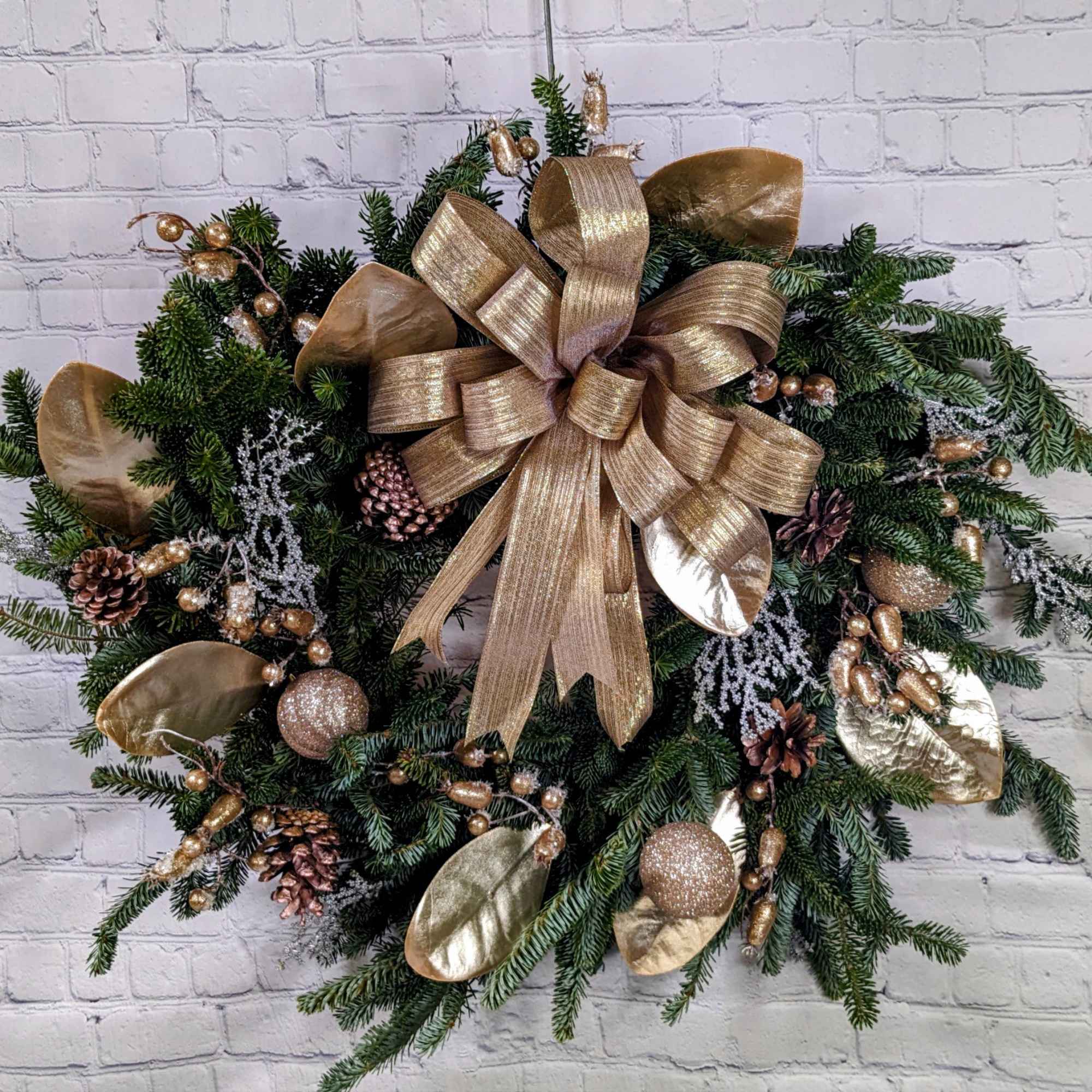 Our Golden Christmas Wreath is made of fresh Frasier pine. Decorations for