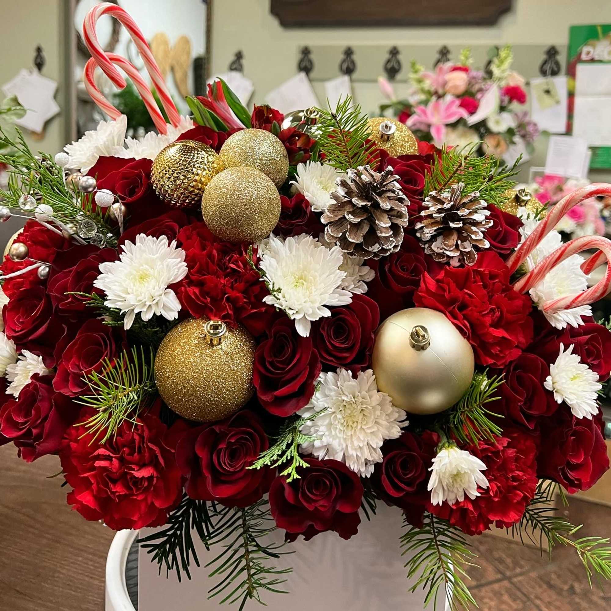 Christmas flower box filled with red roses, carnation, poms, alstomerias, Christmas green