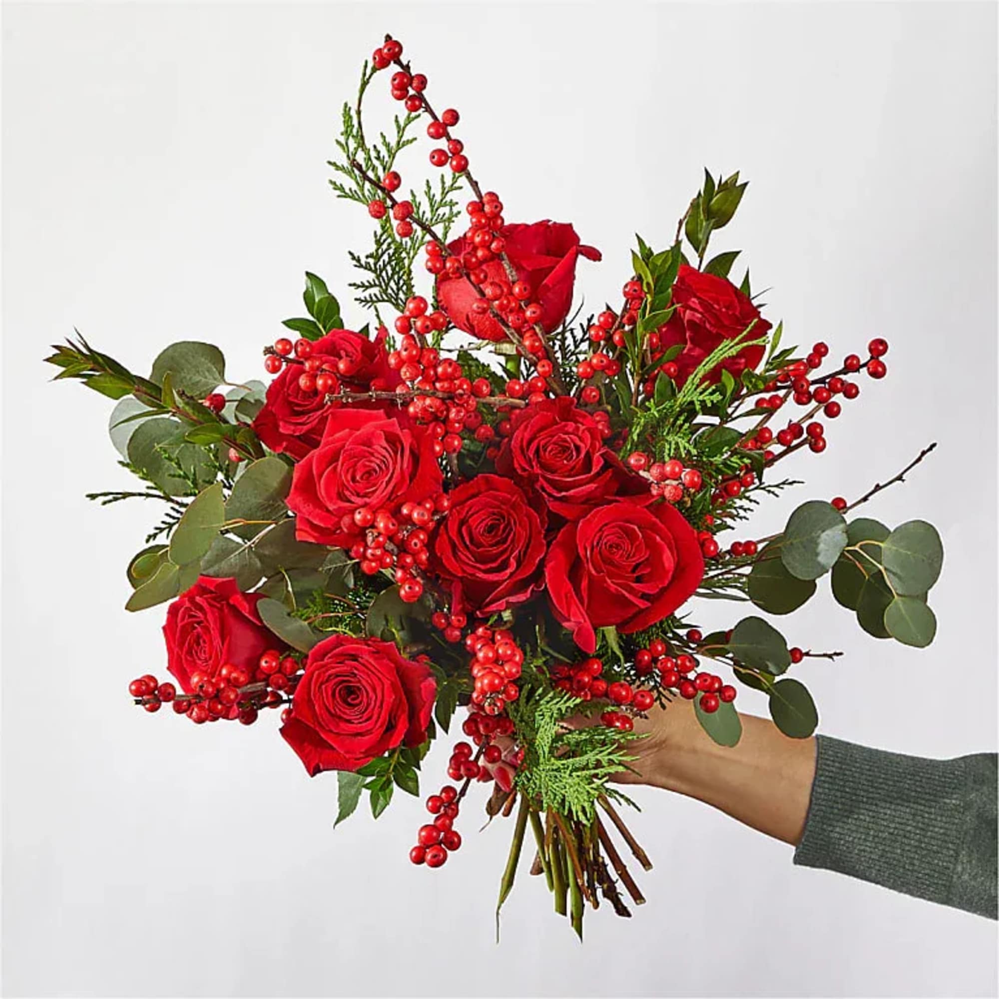 DECEMBRRR BOUQUET

Striking red roses, berries and delightful holiday greens make for an