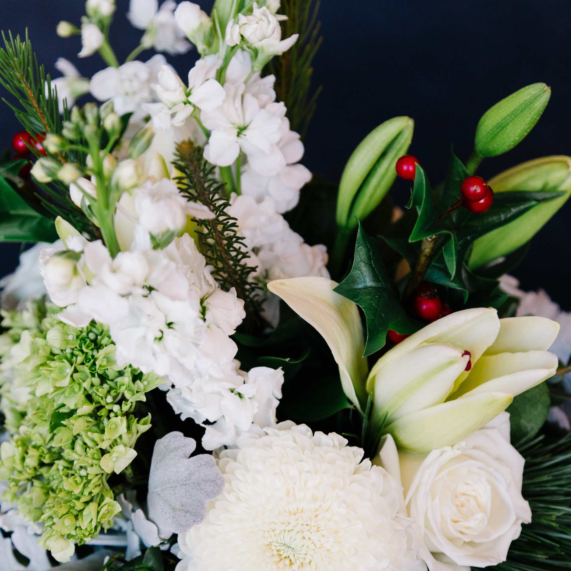 An assortment of beautiful winter white blooms with a touch of festive