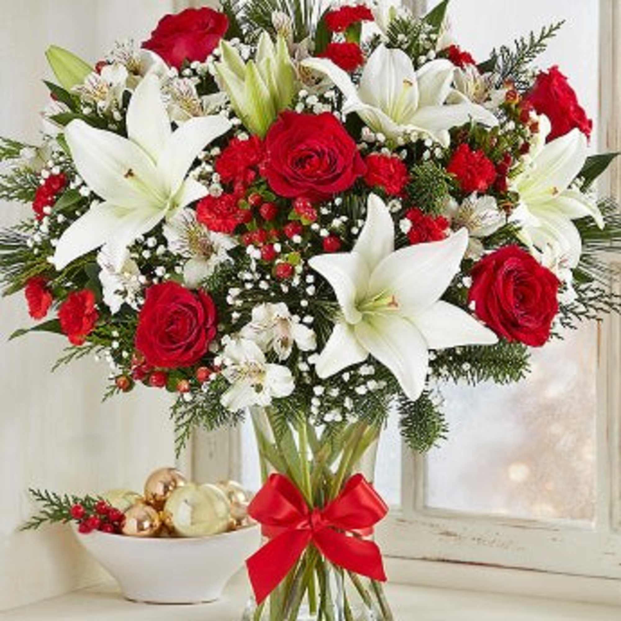  This arrangement with red roses, carnations and mini carnations; white Asiatic