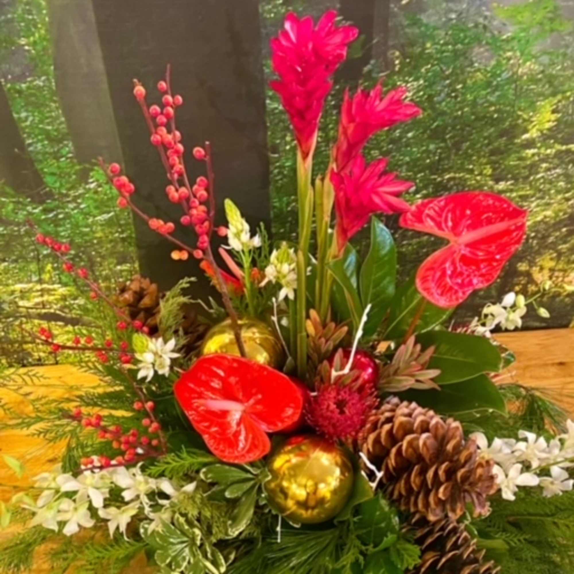 Evergreen boughs, holly, winterberry, Christmas ornaments, and a mix of tropical and