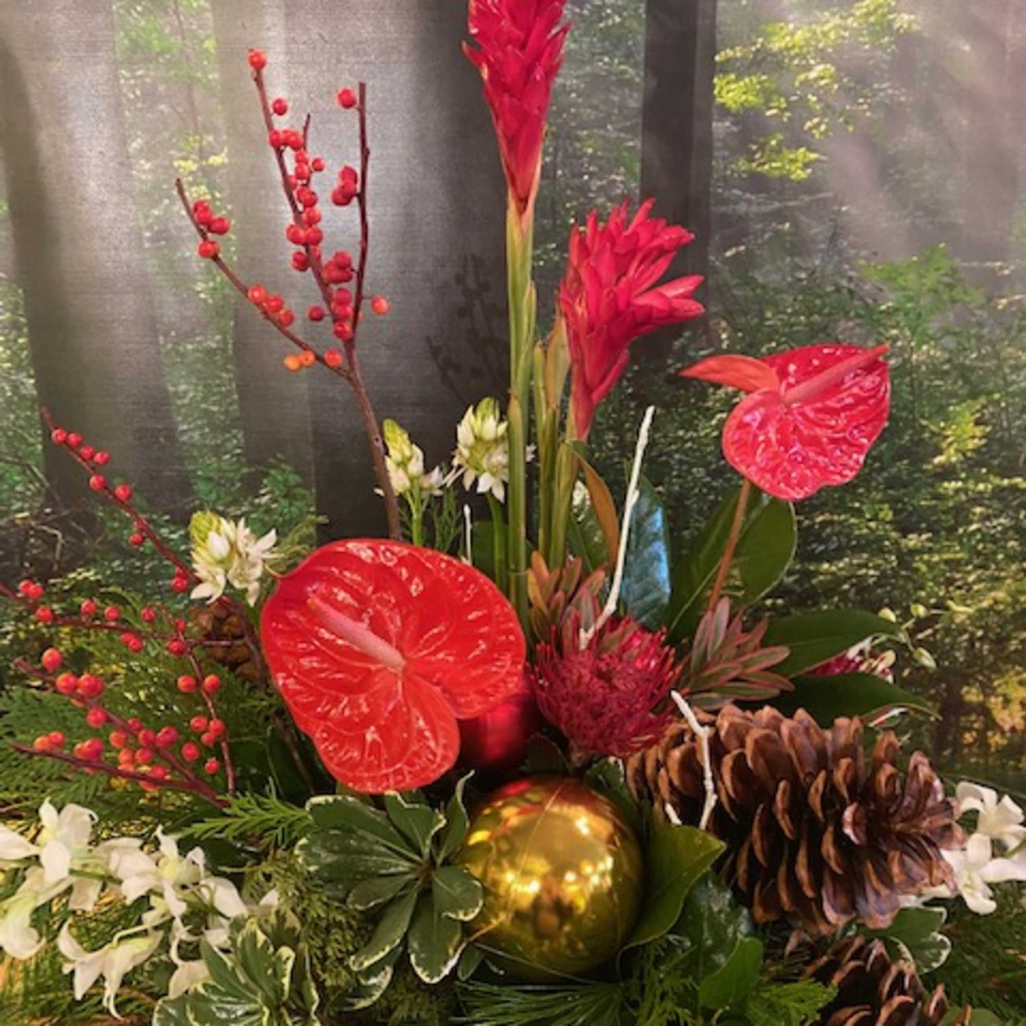 Evergreen boughs, holly, winterberry, Christmas ornaments, and a mix of tropical and