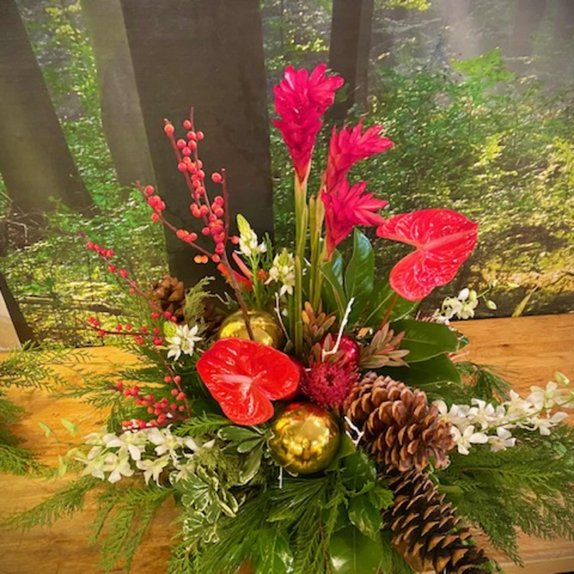 Evergreen boughs, holly, winterberry, Christmas ornaments, and a mix of tropical and