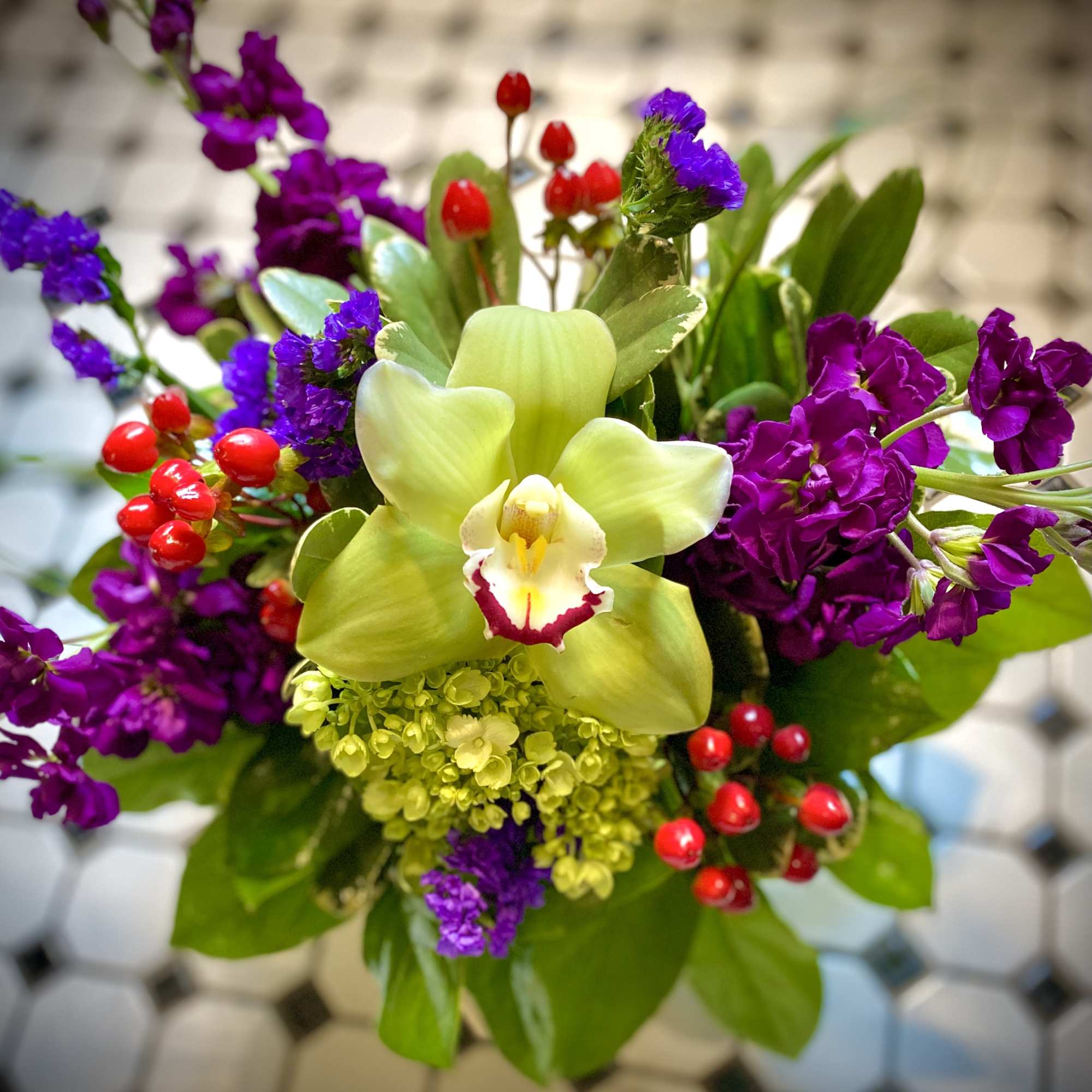 Beautiful tones of rich purple, red and green grace this beautiful design