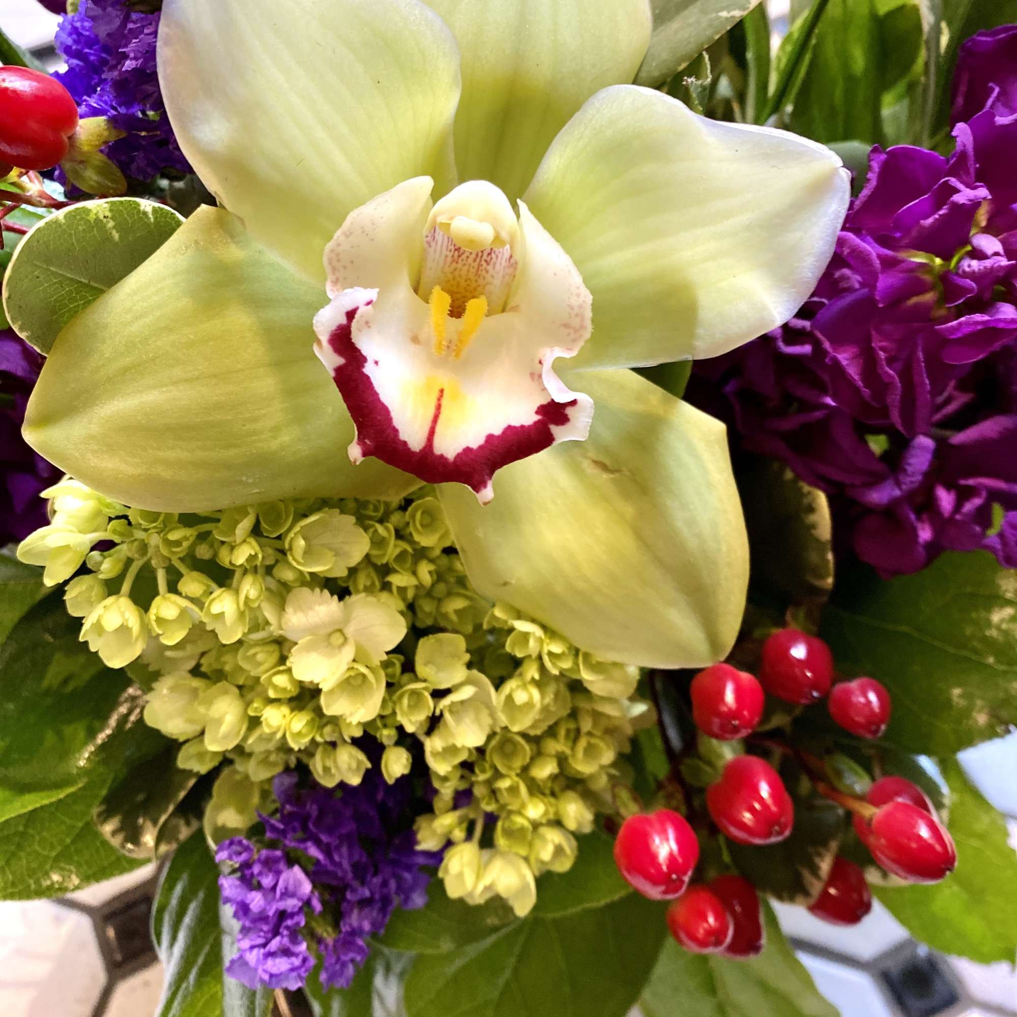 Beautiful tones of rich purple, red and green grace this beautiful design