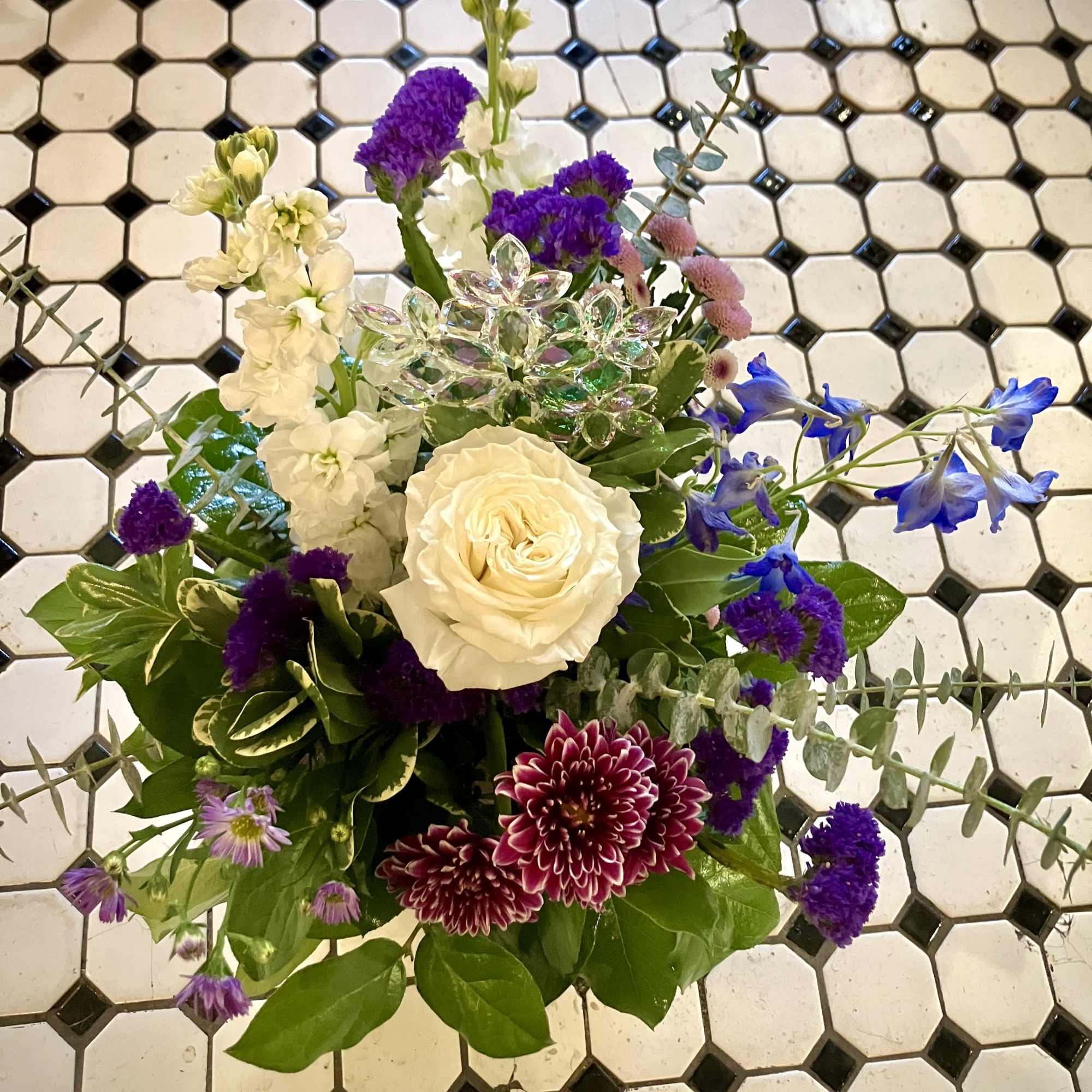 This gorgeous holiday arrangement features a beautiful Rose, Mums, Stock, Status and