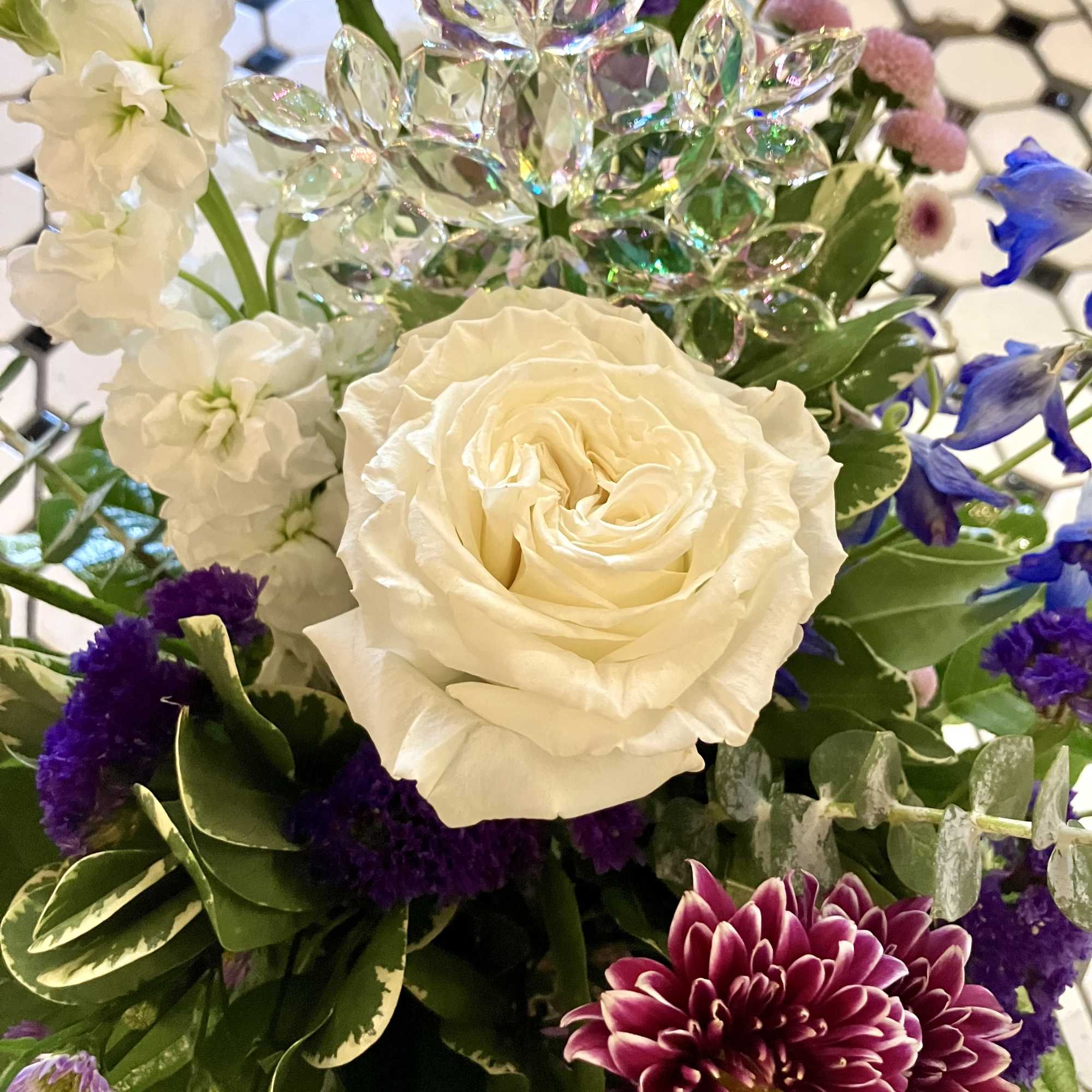 This gorgeous holiday arrangement features a beautiful Rose, Mums, Stock, Status and