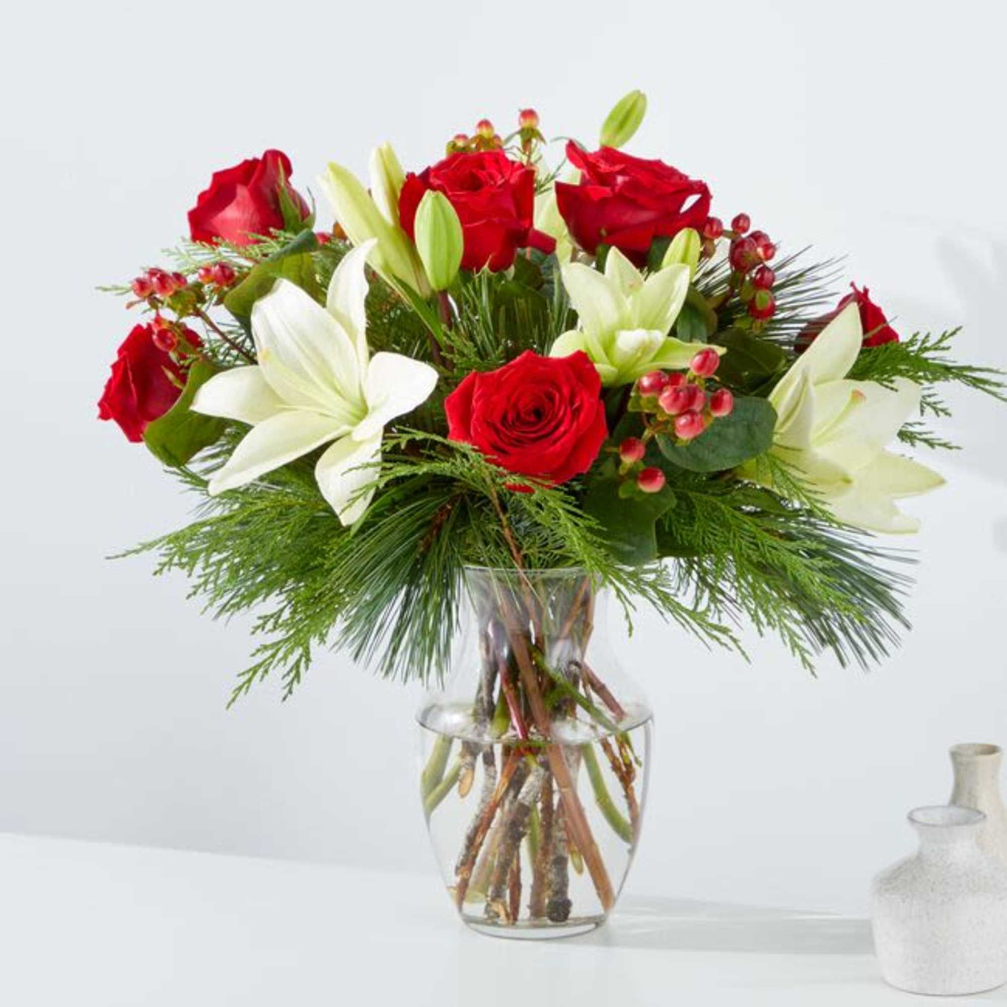 The &quot;Evergreen Delight&quot; flower arrangement beautifully marries the freshness of evergreens with