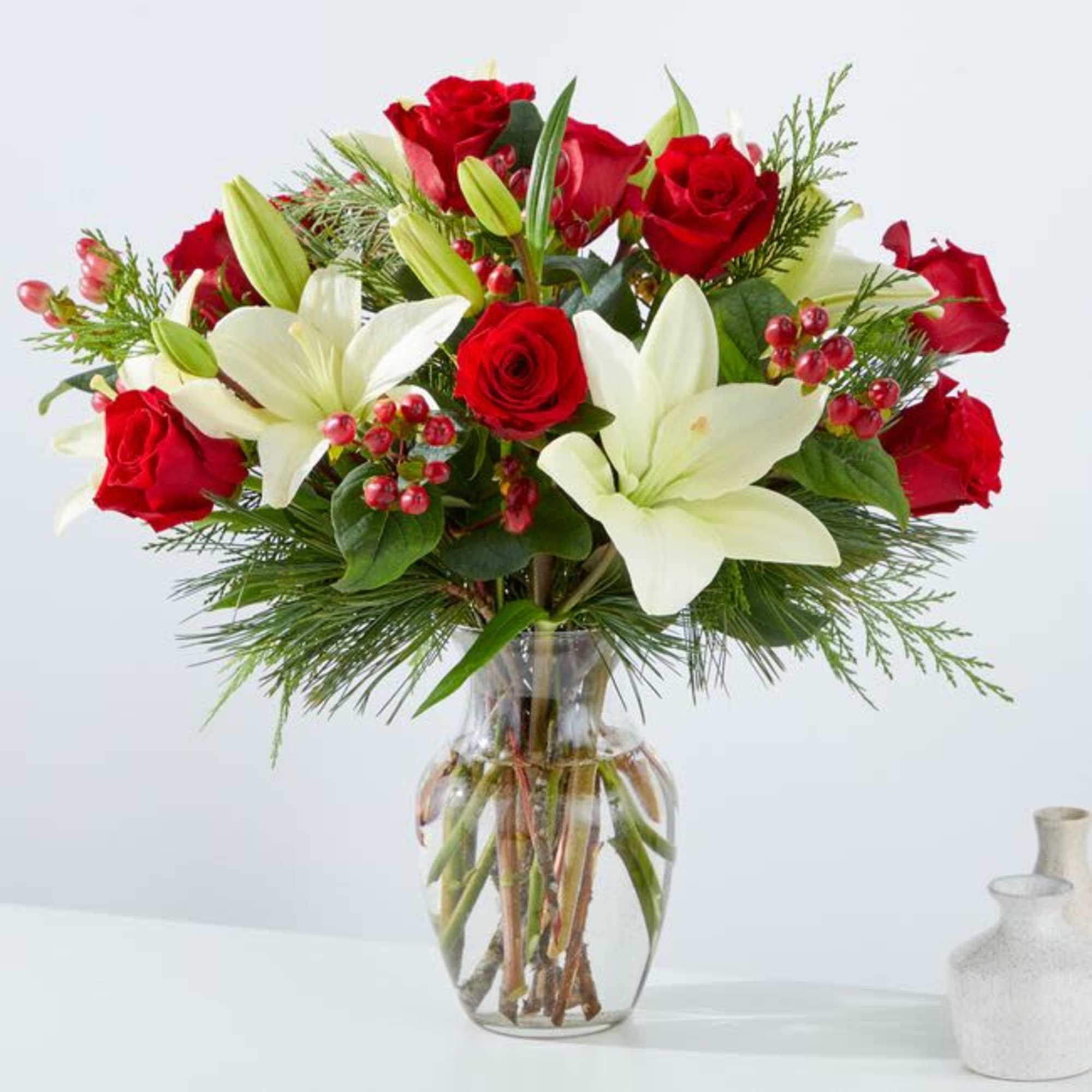 The &quot;Evergreen Delight&quot; flower arrangement beautifully marries the freshness of evergreens with