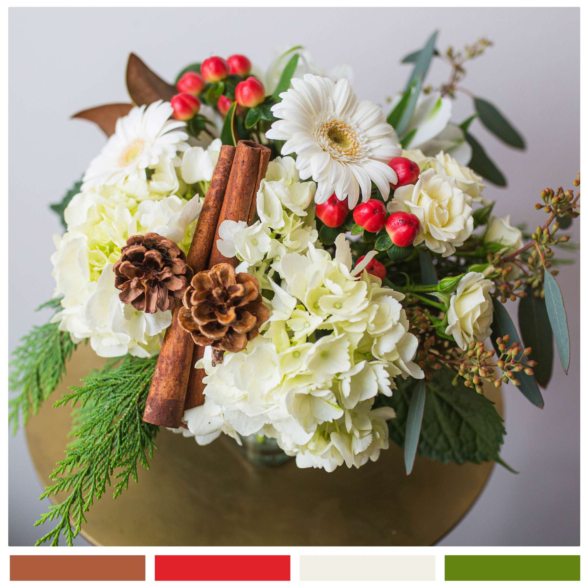 A sweet, low centerpiece, filled with winter greens, lush hydrangea, spray roses
