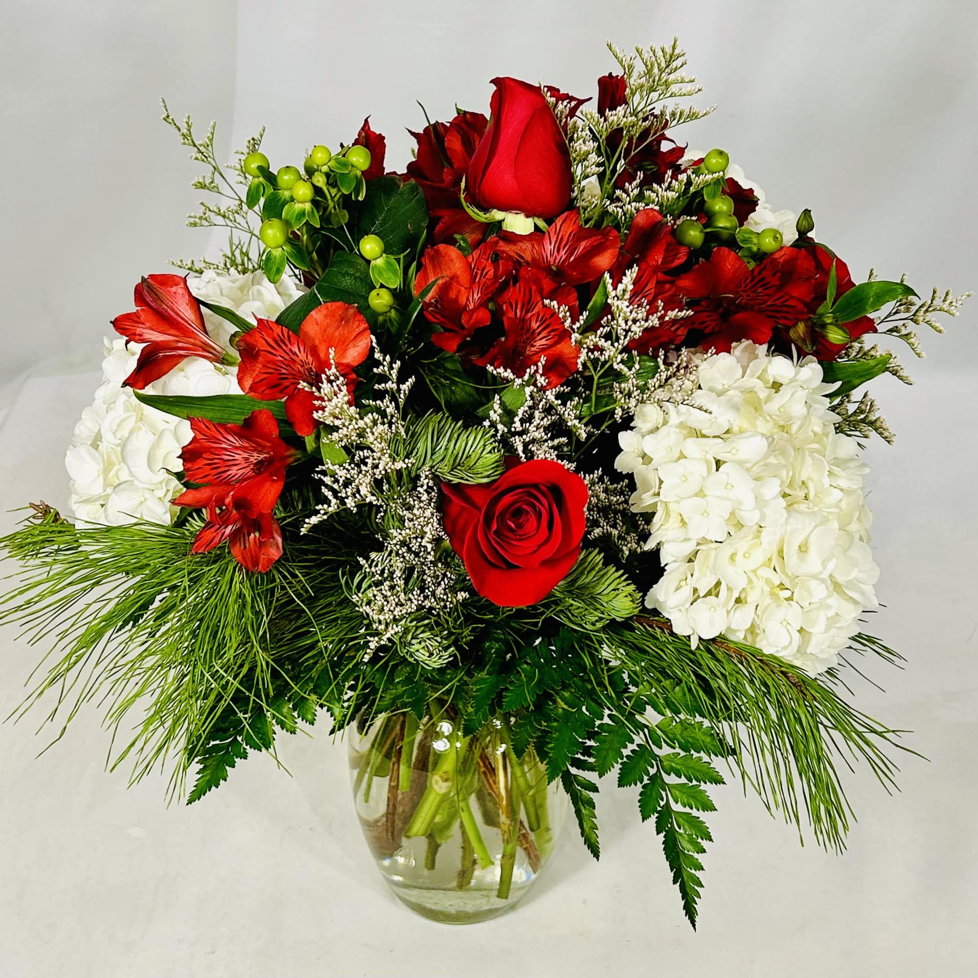 Splendid arrangement of roses, white hydrangeas, red alstroemeria and other flowers including