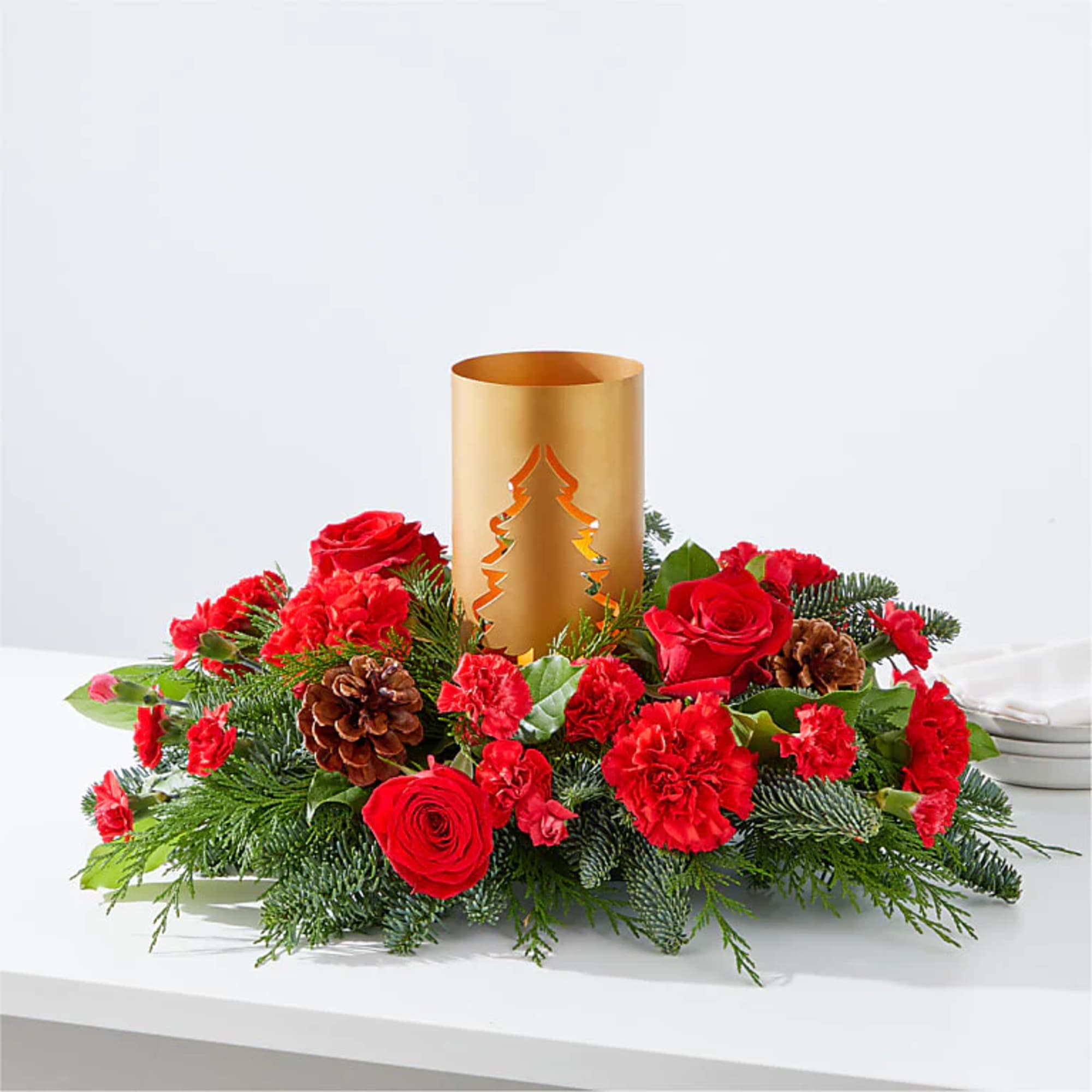 Add blustery cheer to any holiday table with this coniferous centerpiece studded