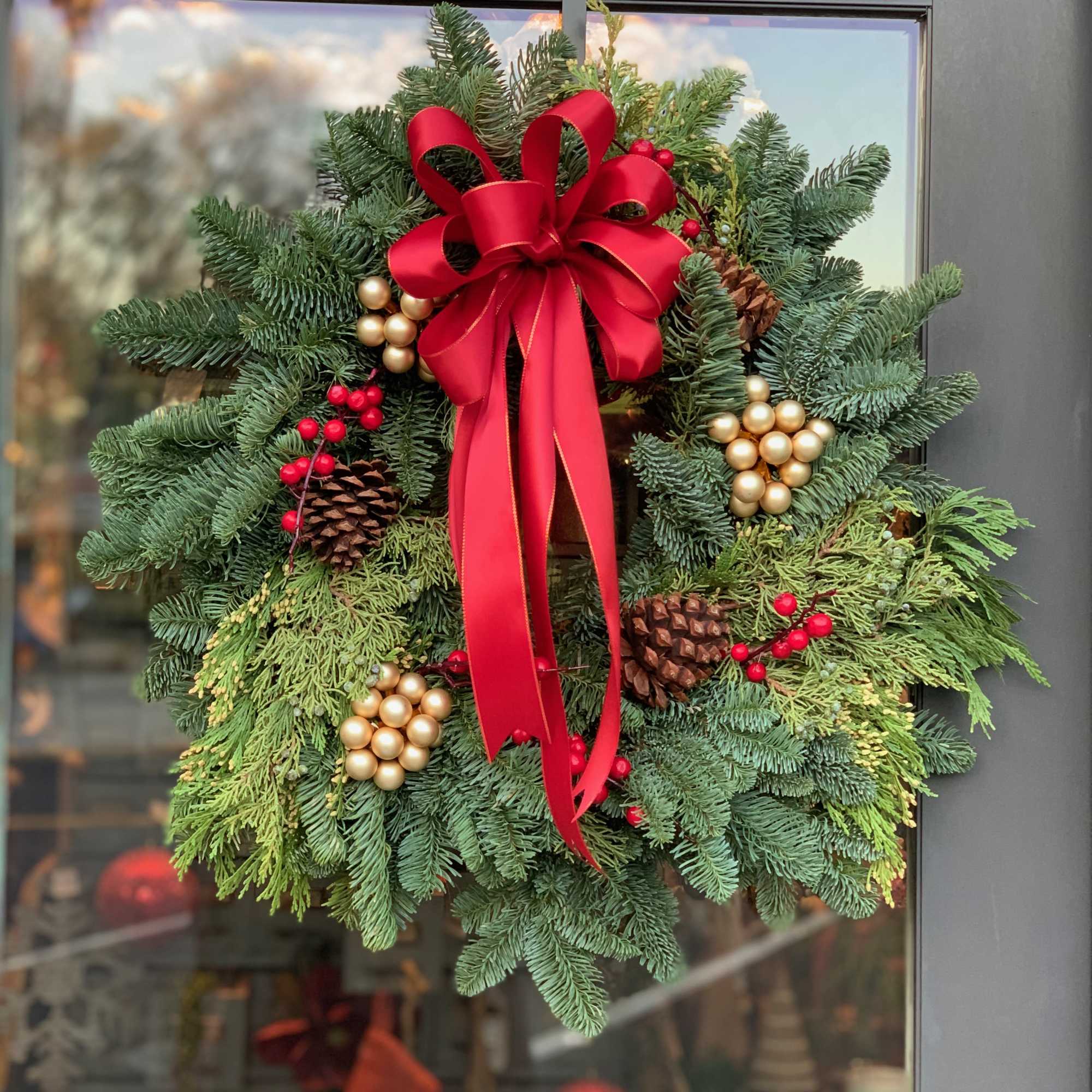 This festive wreath made with real evergreen branches will brighten up any