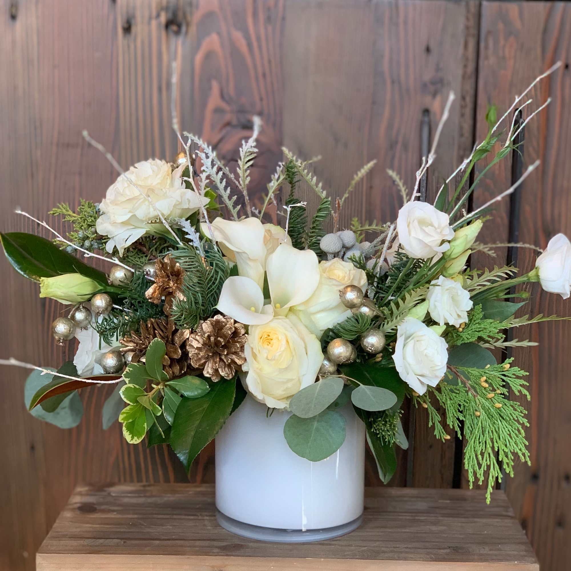 Enter the wondrous snowy realm of holiday delight with this elegant arrangement.