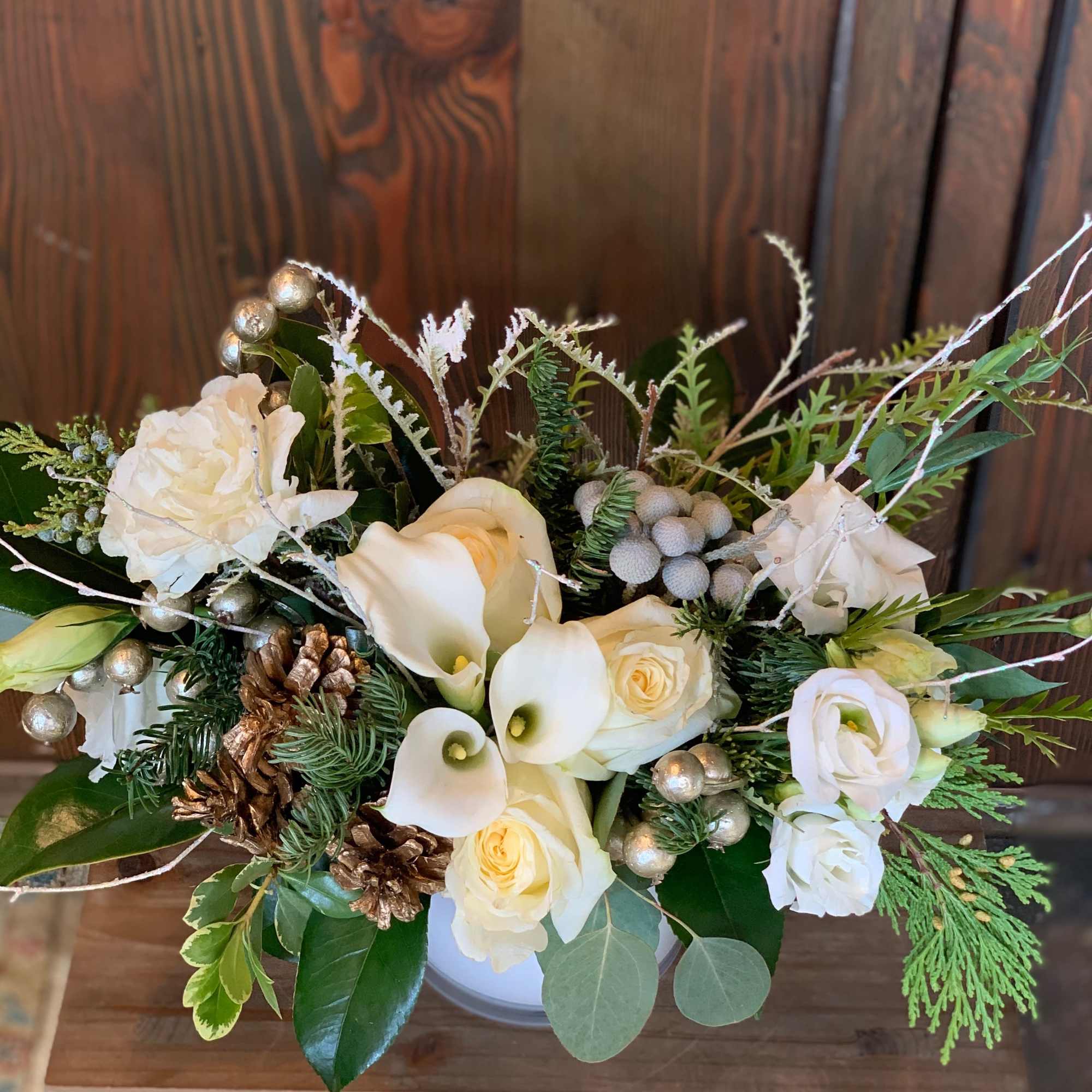 Enter the wondrous snowy realm of holiday delight with this elegant arrangement.