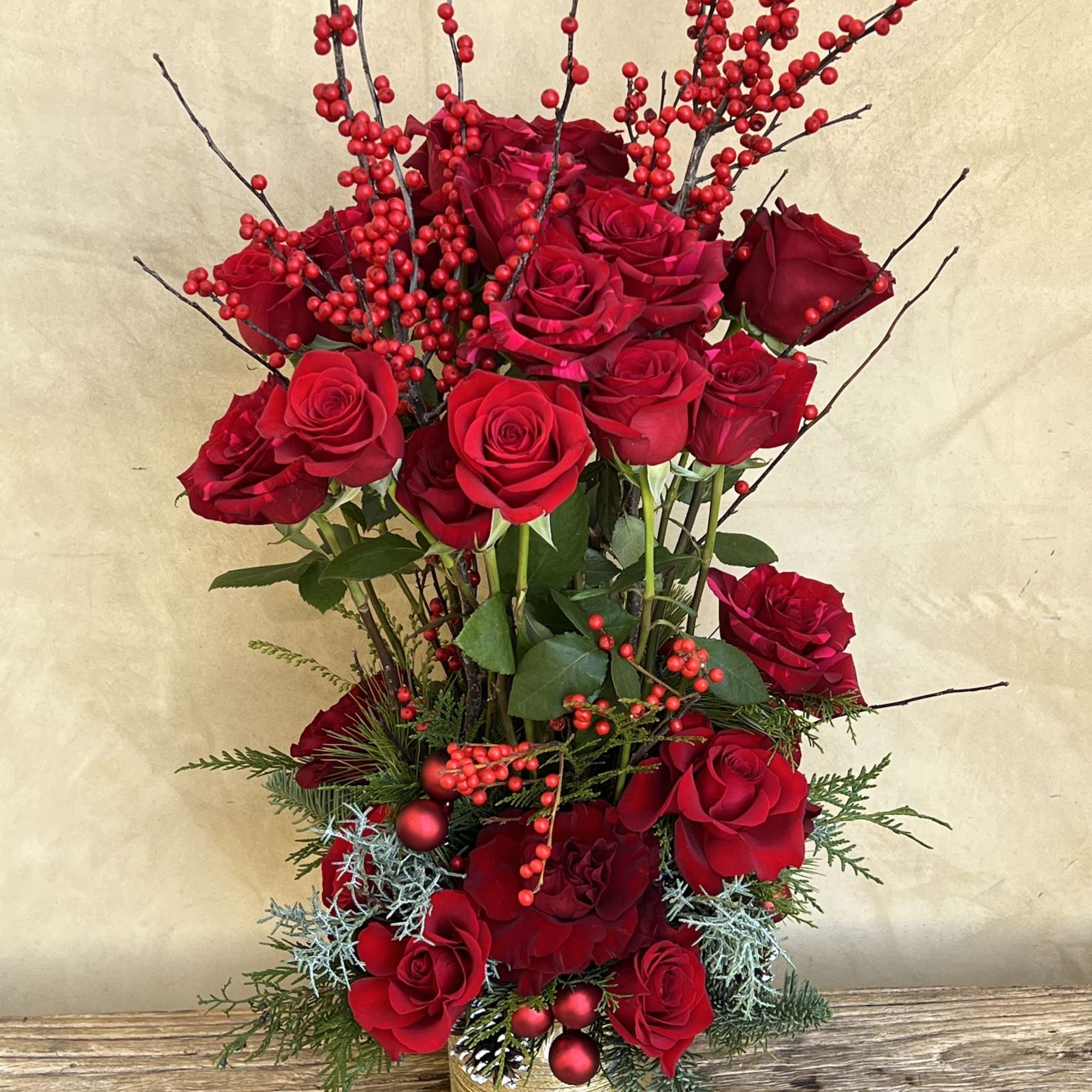 Red roses galore, shine bright in an epic topiary form with florals