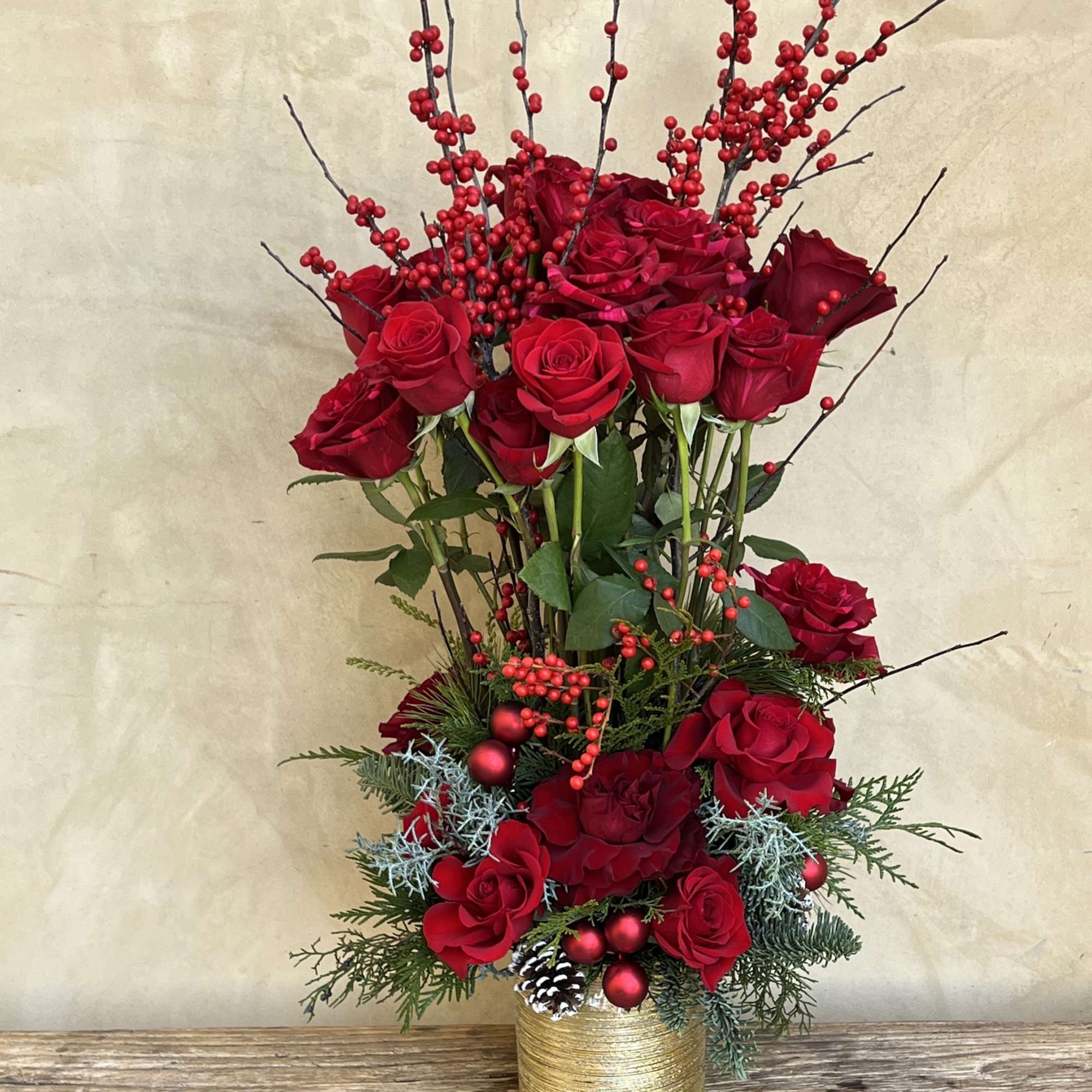 Red roses galore, shine bright in an epic topiary form with florals