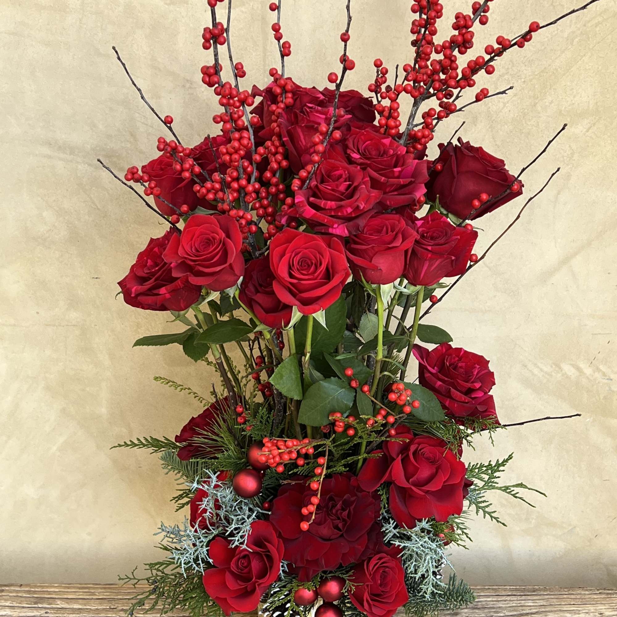 Red roses galore, shine bright in an epic topiary form with florals