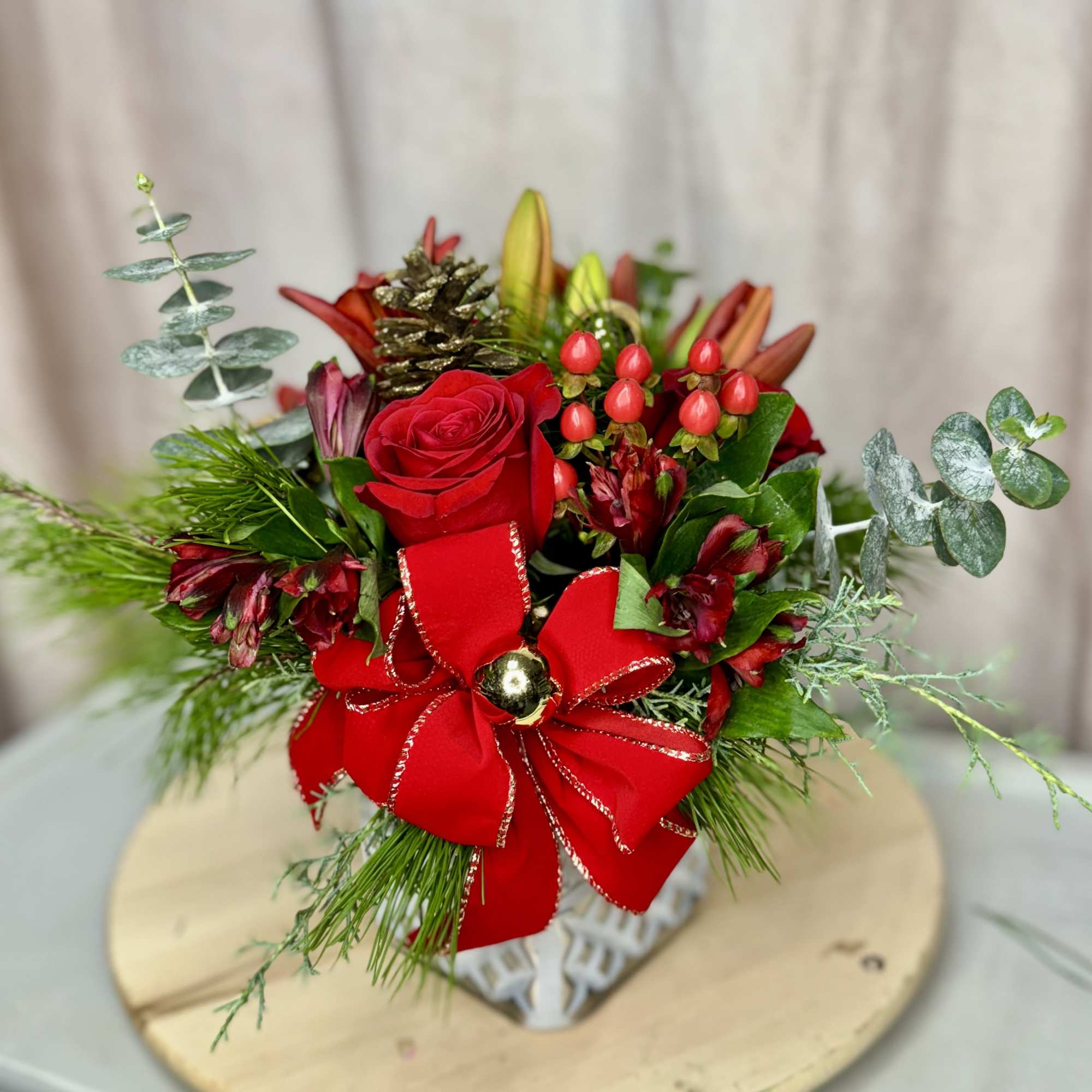 Celebrate the season with Holiday Harmony, a stunning arrangement featuring vibrant red