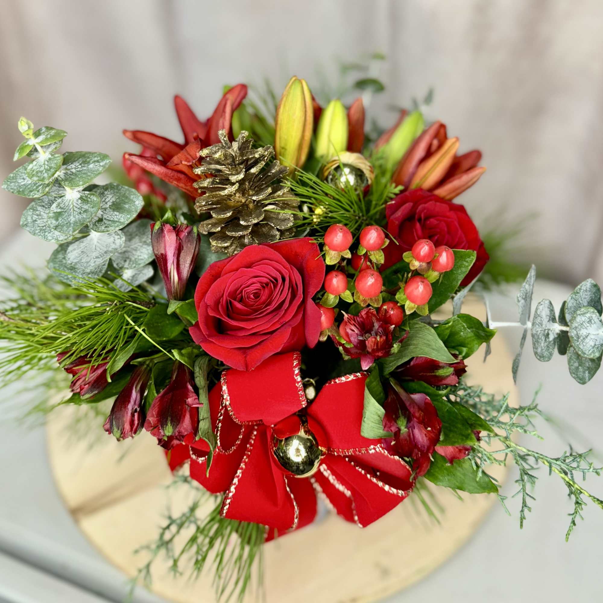 Celebrate the season with Holiday Harmony, a stunning arrangement featuring vibrant red