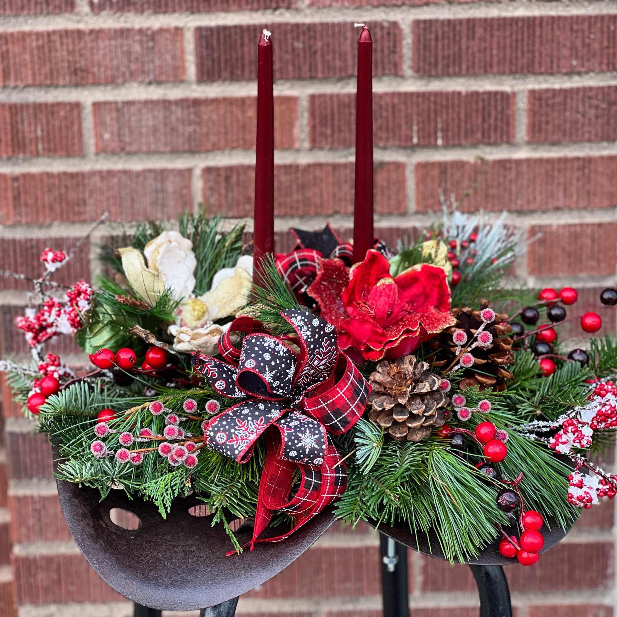 Made entirely of a variety of Christmas greens, berries, festive ribbon and