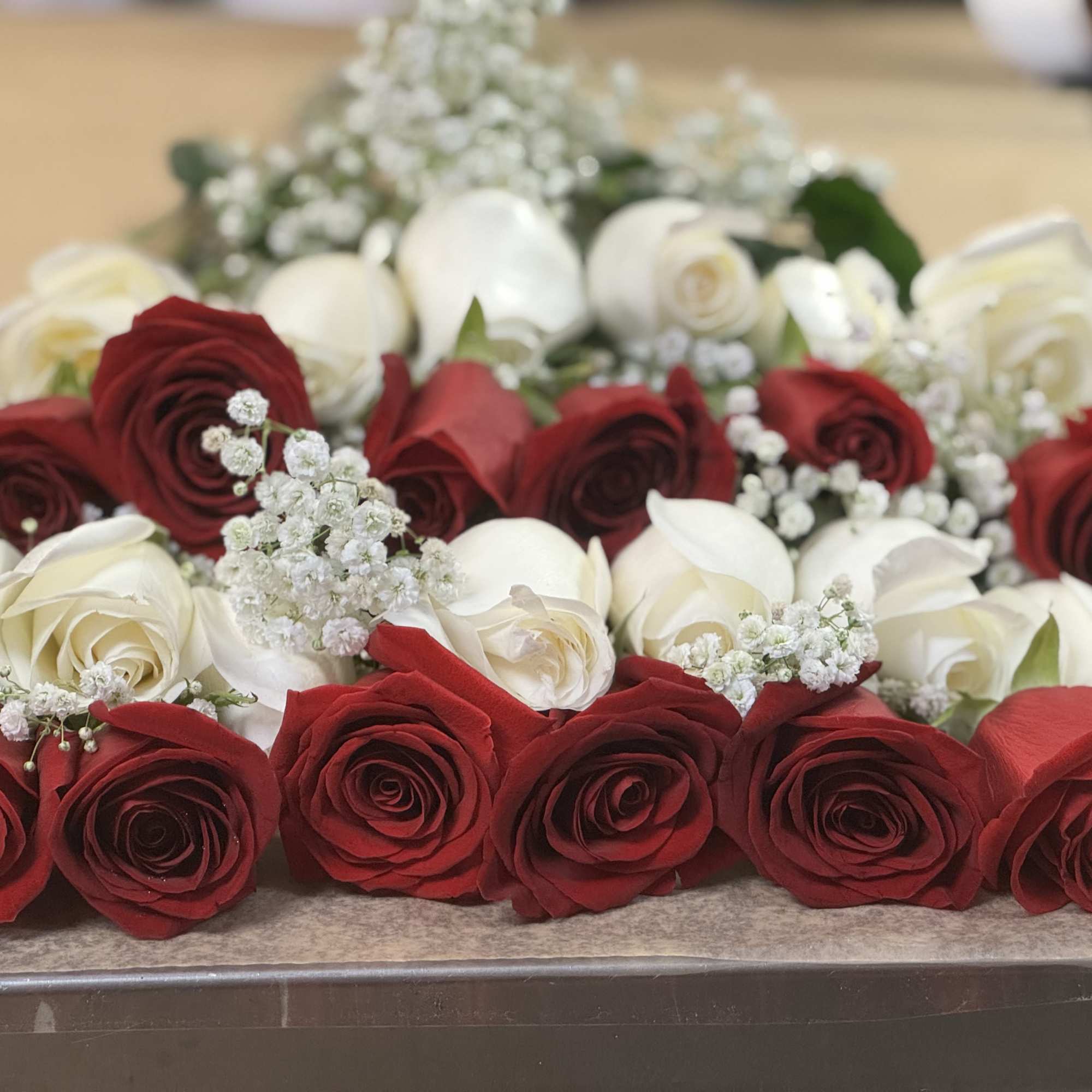18 red and white long stem roses prepared presentation style with greens