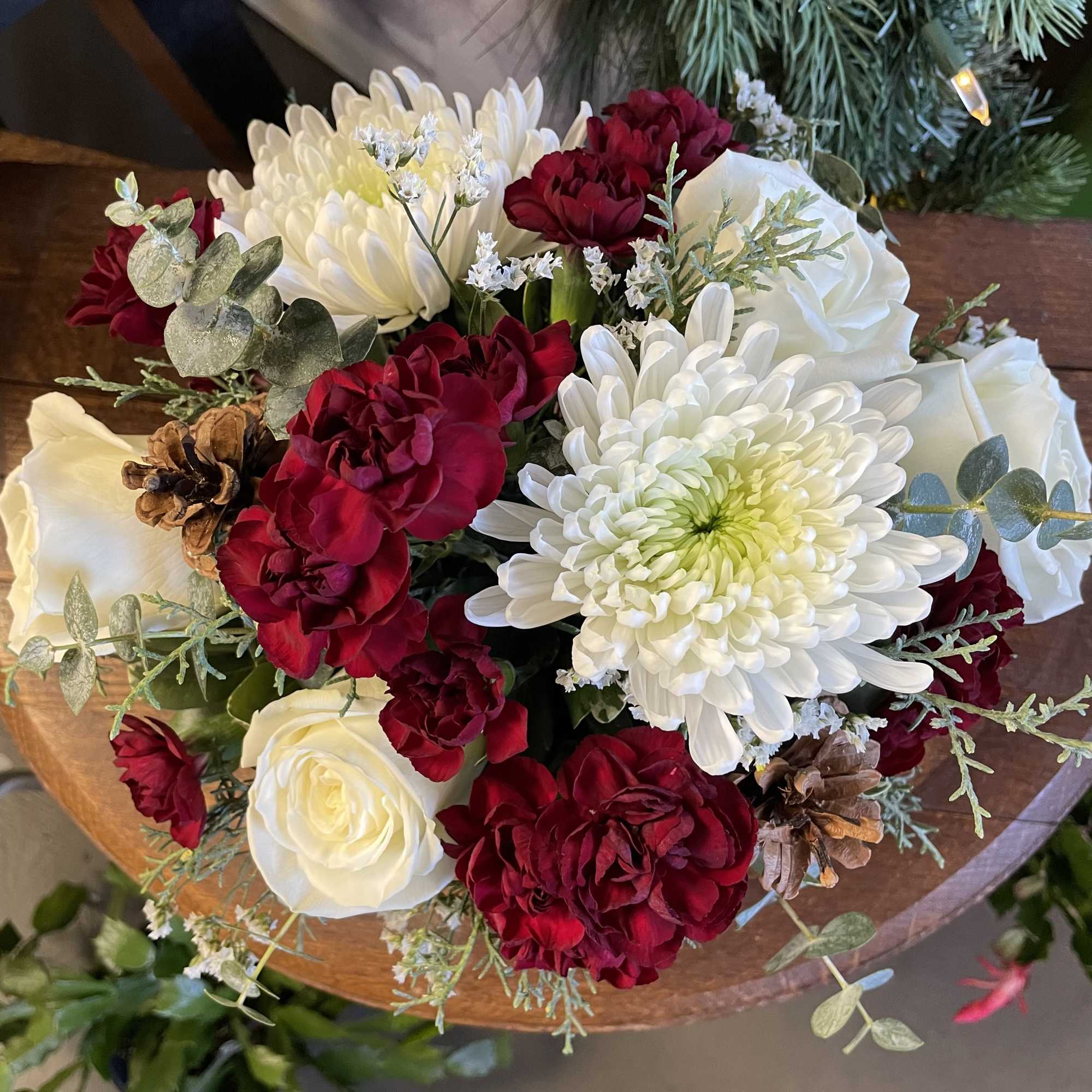 A keepsake ceramic mug featuring white roses, white cremones, burgundy mini carnations