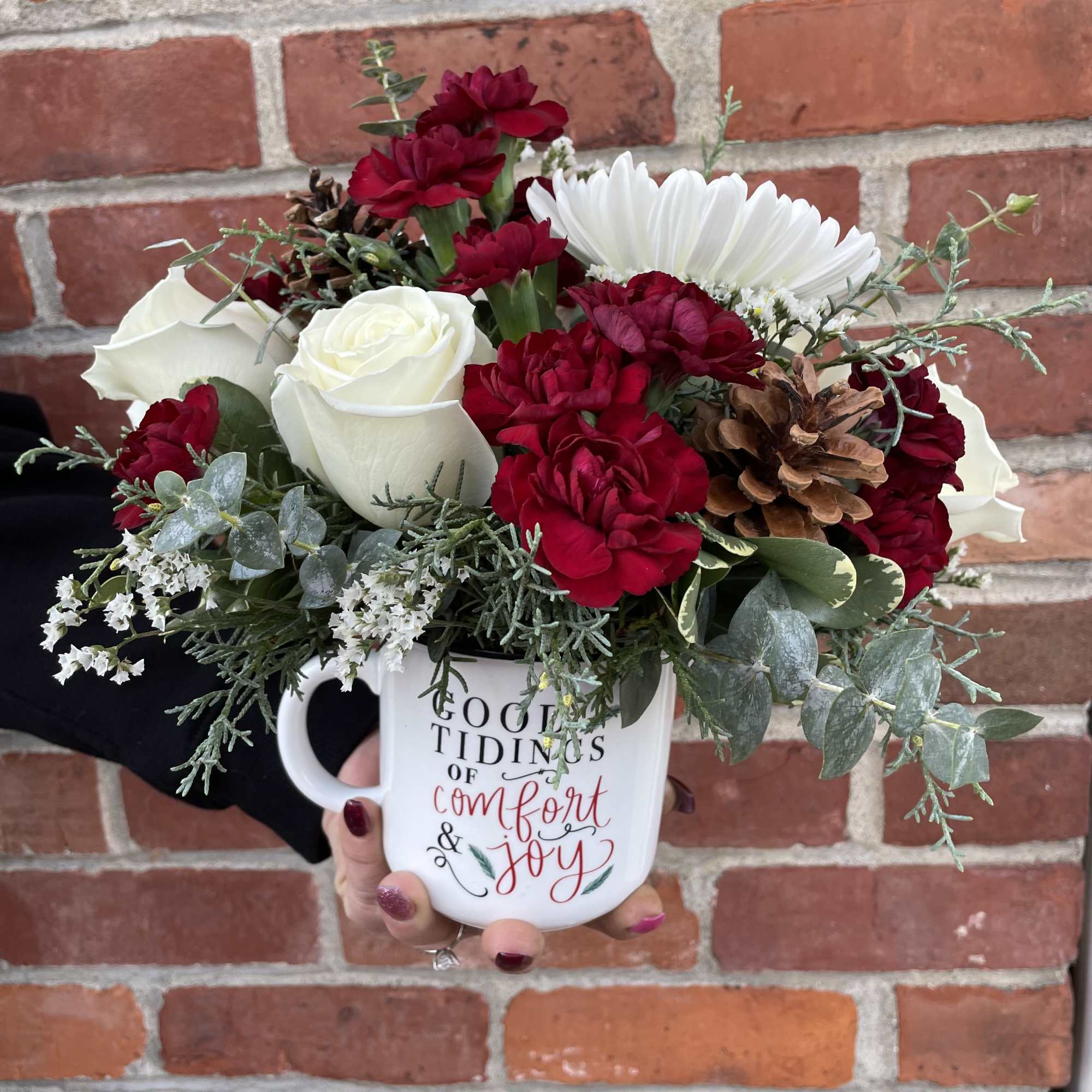 A keepsake ceramic mug featuring white roses, white cremones, burgundy mini carnations