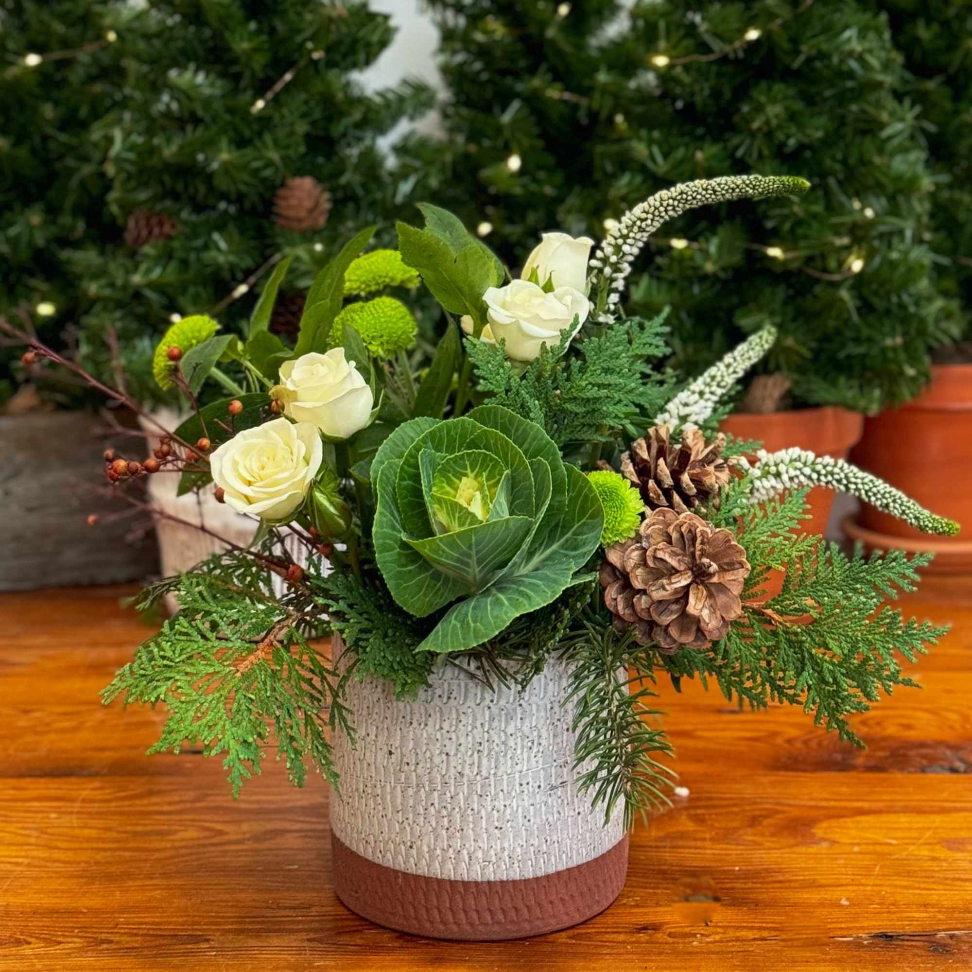 This arrangement is designed to last the season, featuring spray roses with