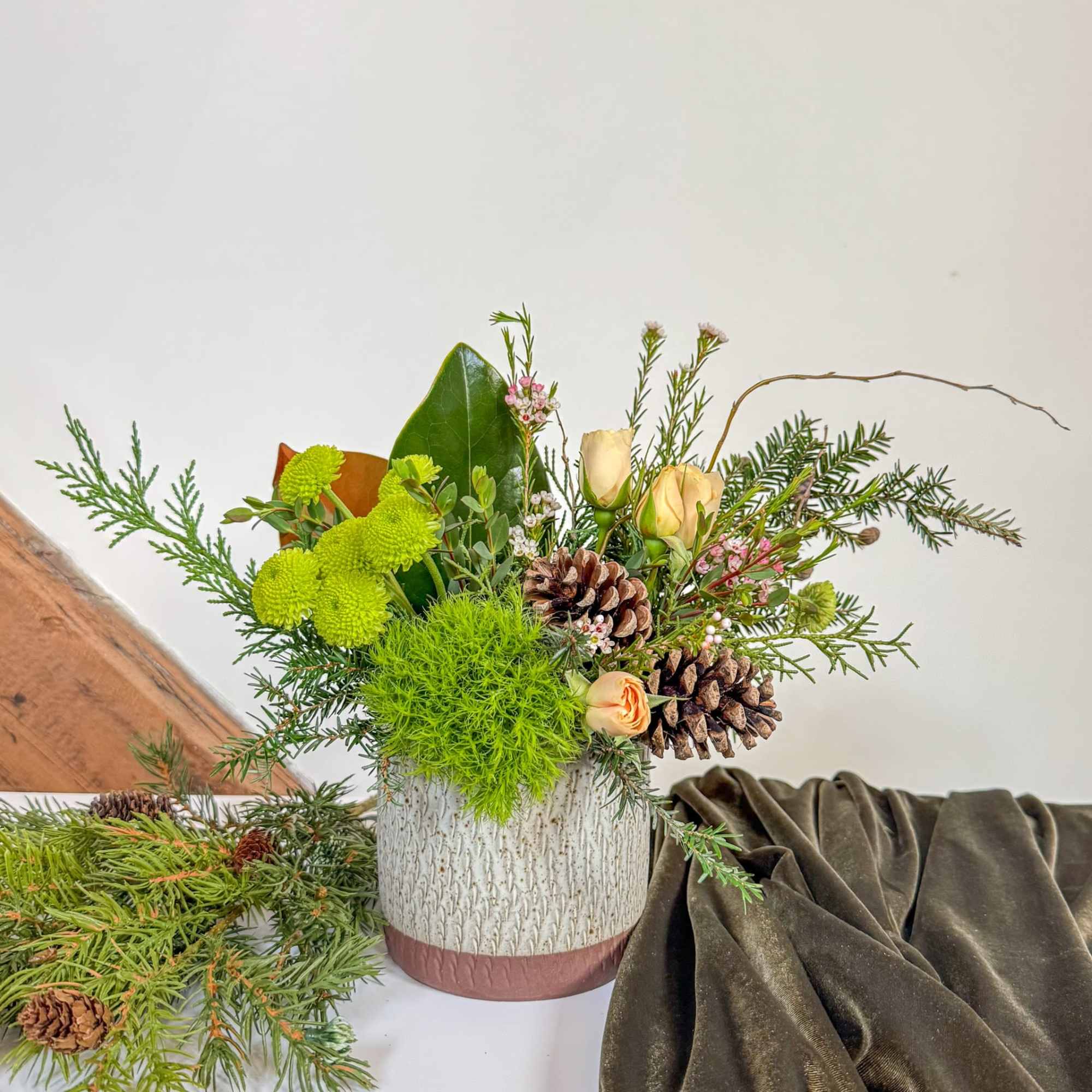 This arrangement is designed to last the season, featuring spray roses with