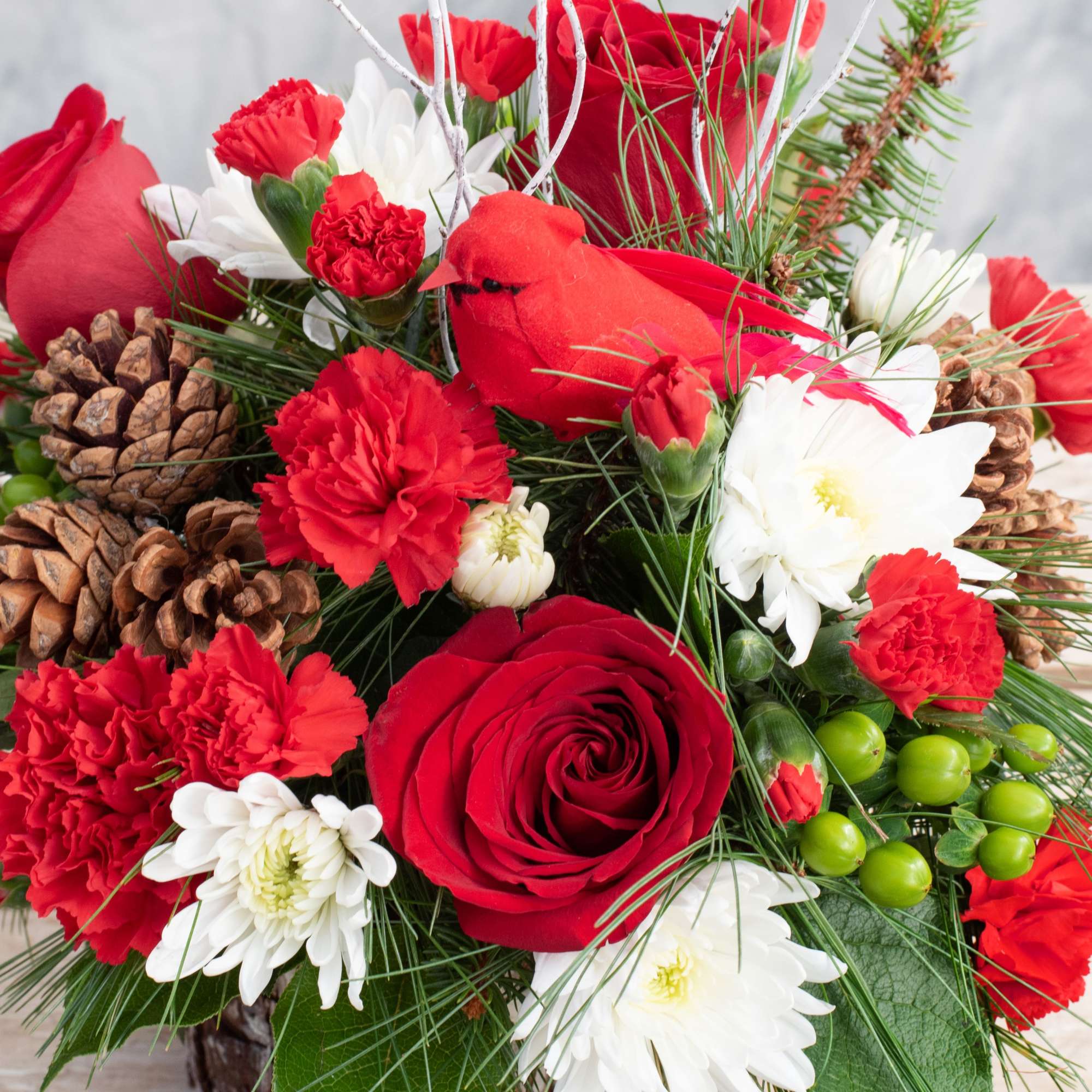 Long lasting red carnations, white chrysanthemums, red roses and a nice mix