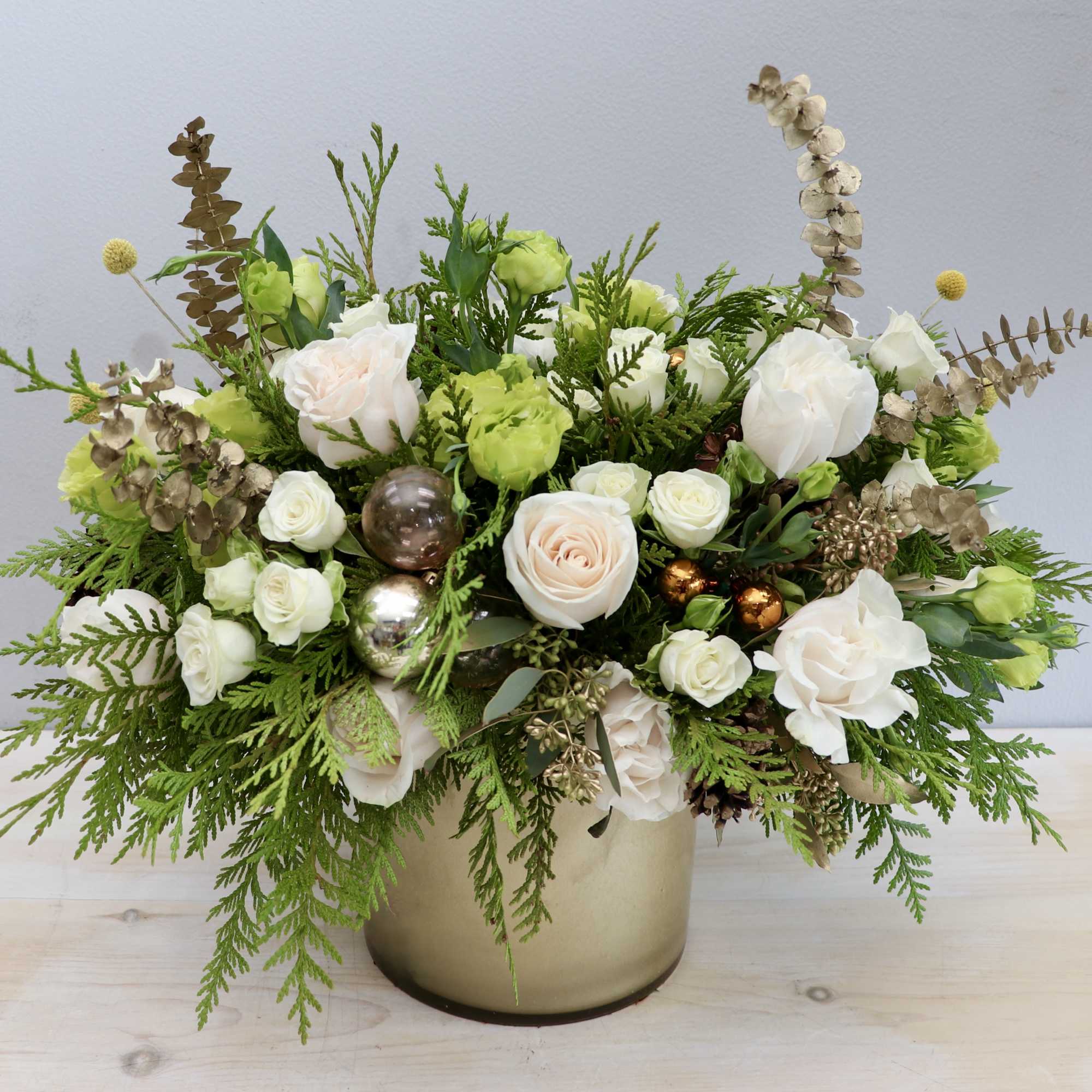 The &quot;Champagne Sparkle Holiday Arrangement&quot; exudes elegance and festivity, blending ivory and
