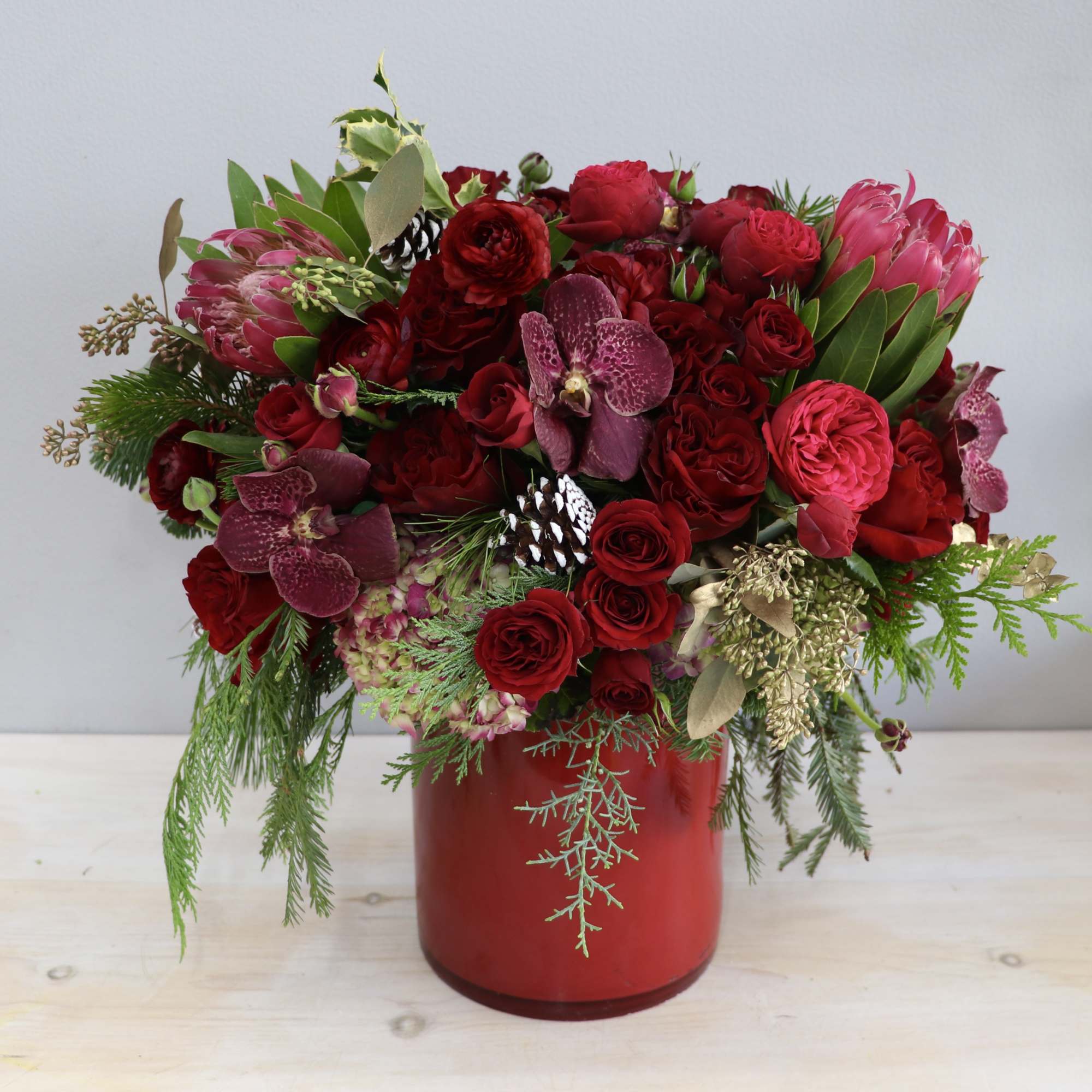 This beautiful arrangement includes a mix of vibrant red roses, hydrangeas, and
