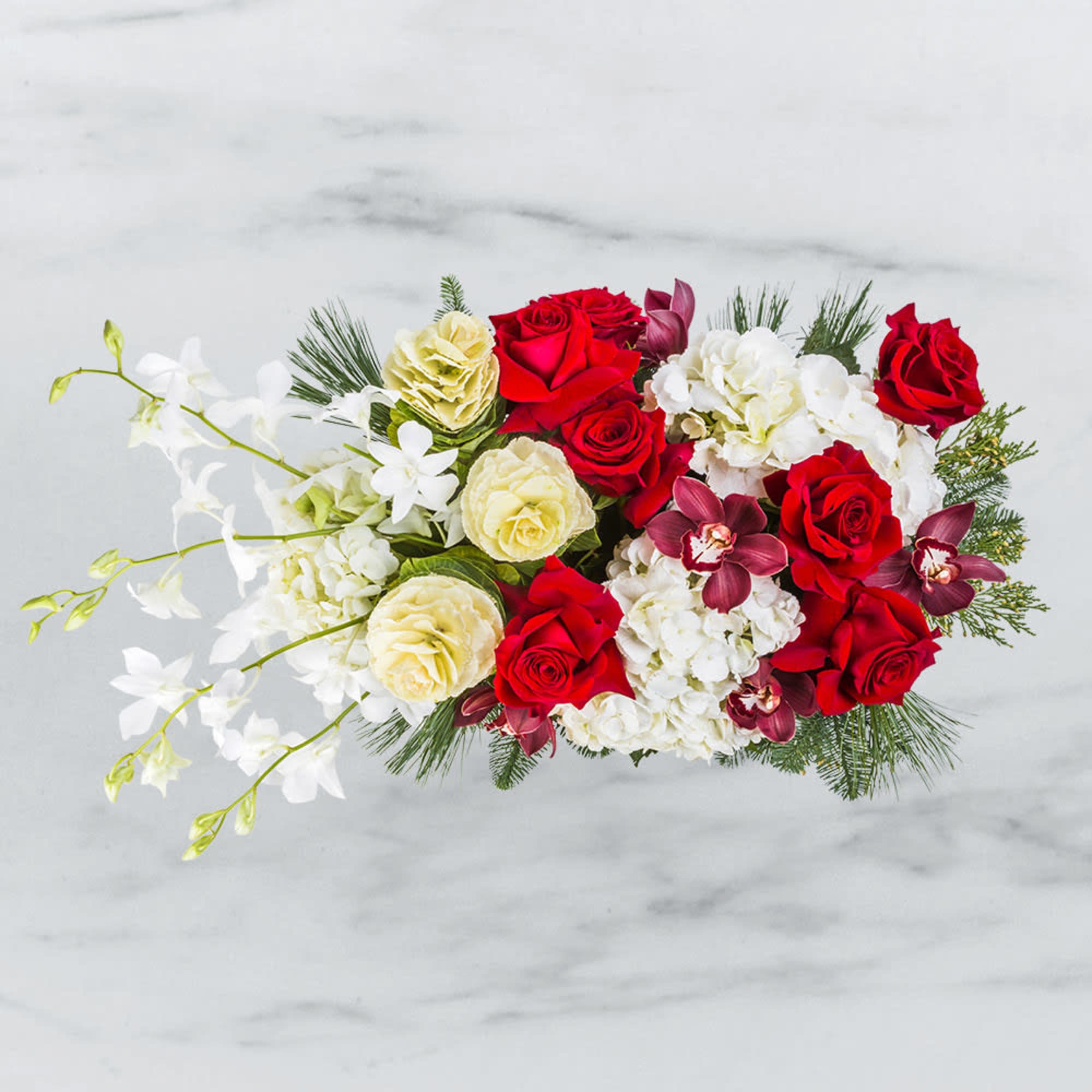 This charming Christmas arrangement radiates rustic elegance, beautifully combining classic holiday colors