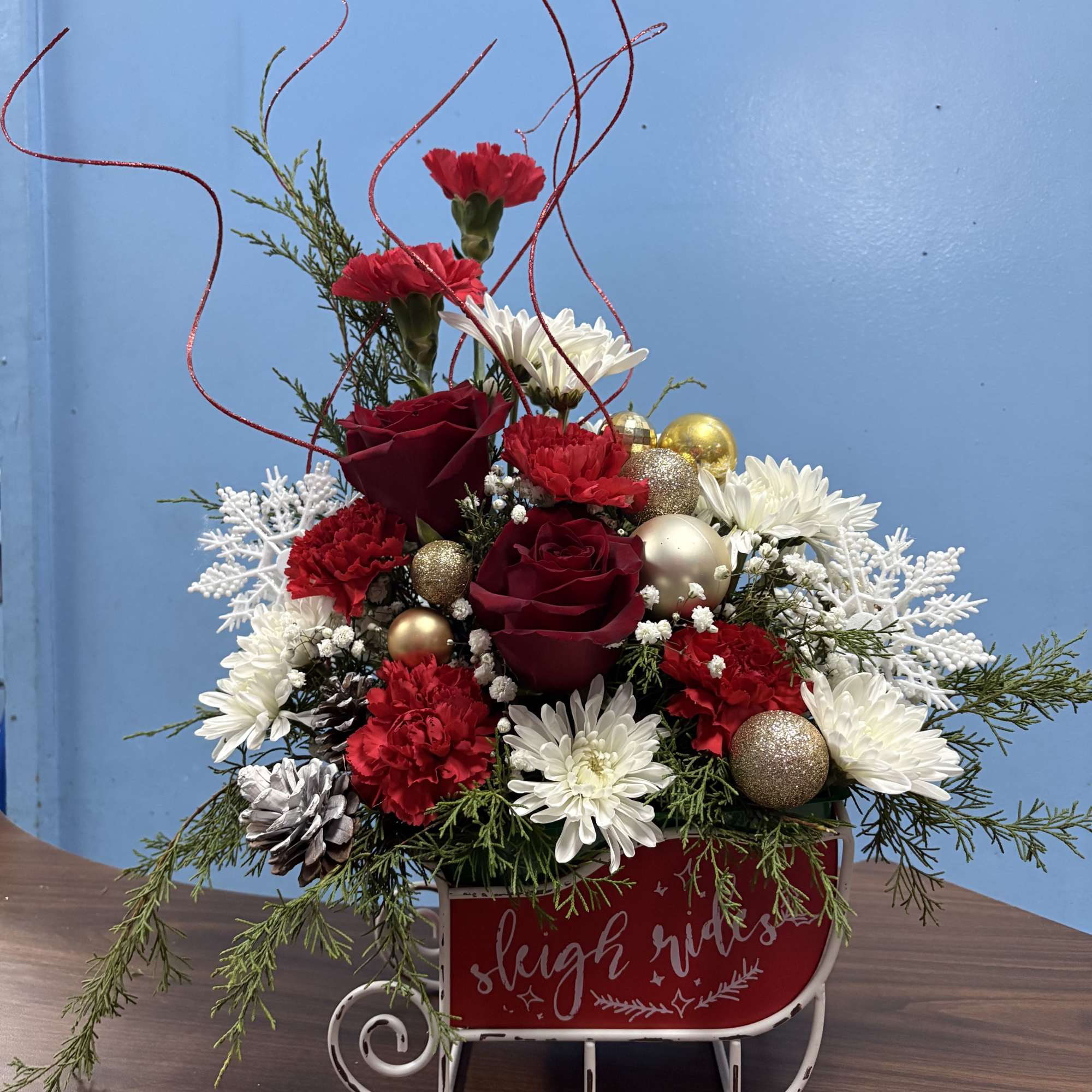 Over the top Christmas arrangement designed in a unique keepsake sled that