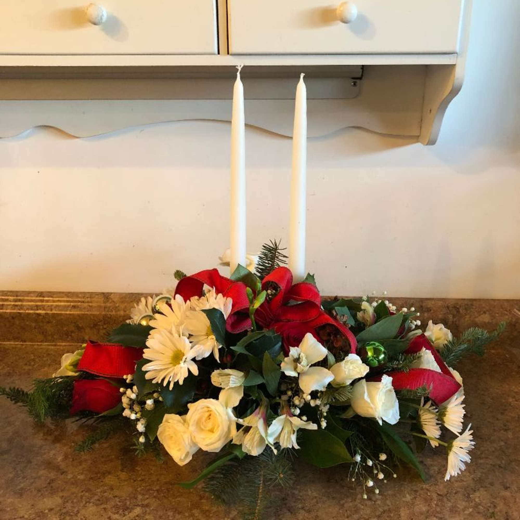 A beautiful assortment of red and white flowers such as alstroemeria, roses