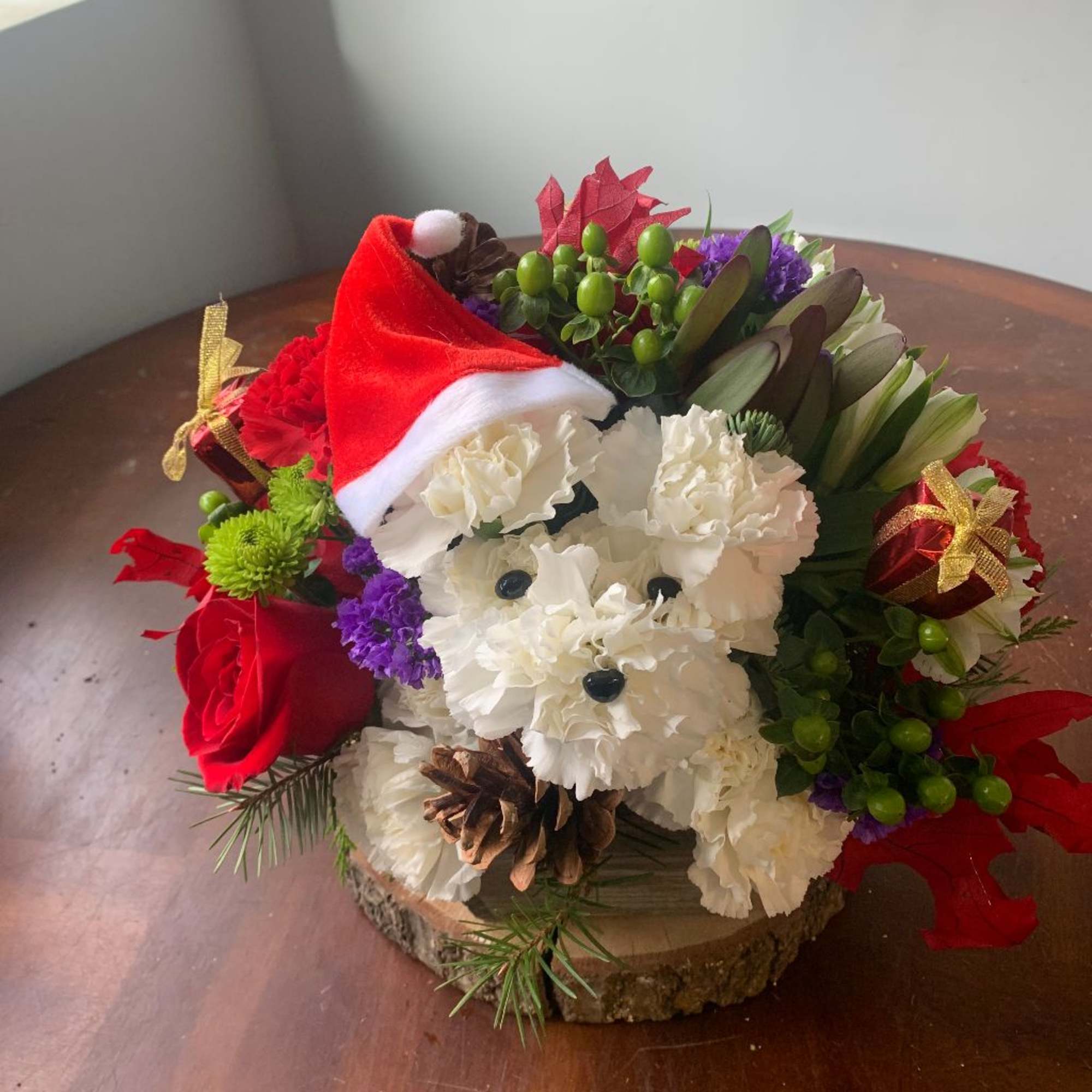 puppy out of carnations... with a round mixed floral arrangement with seasonal