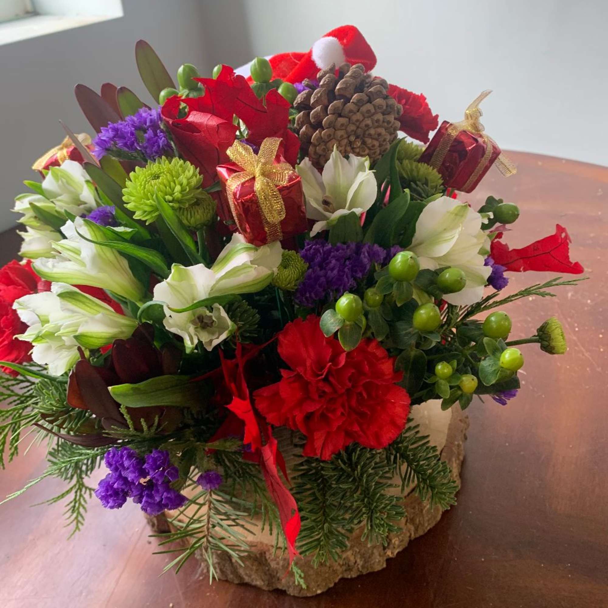 puppy out of carnations... with a round mixed floral arrangement with seasonal