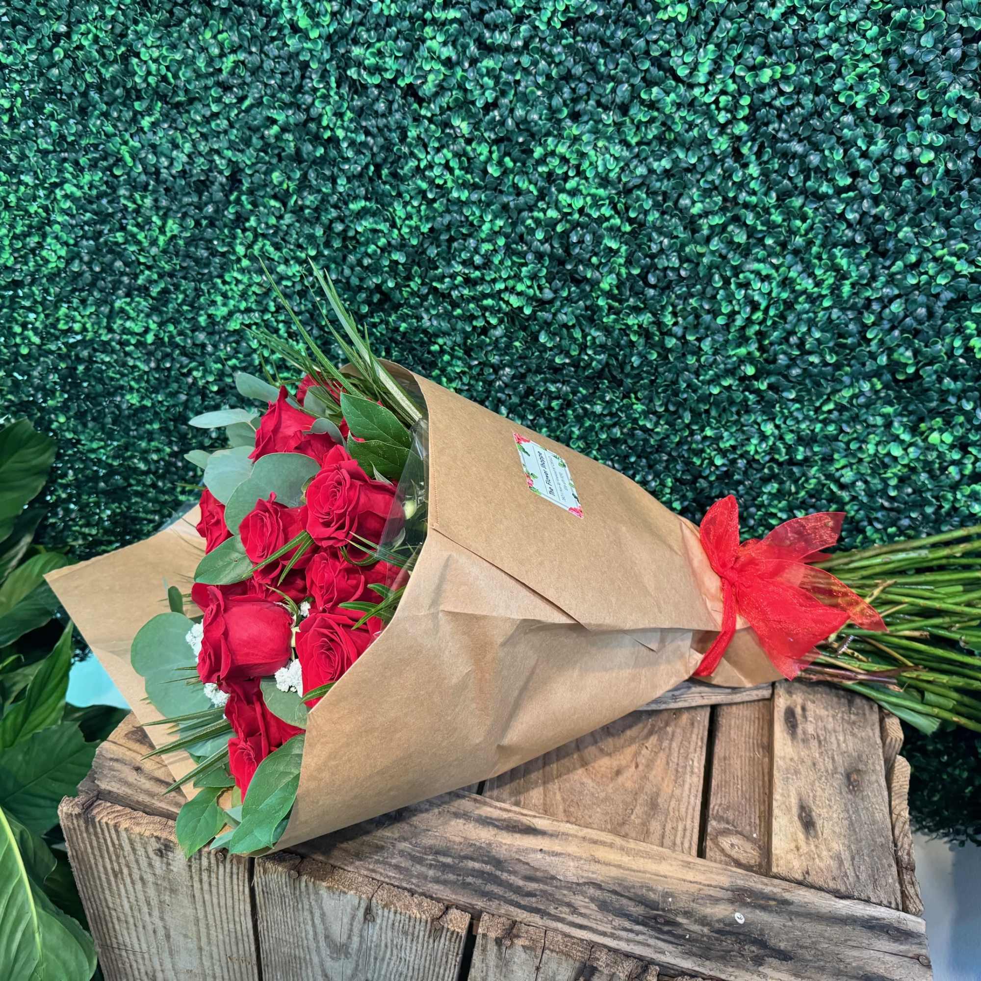 Beautiful 2 Dozen Ecuadorian red roses wrapped in brown paper. 