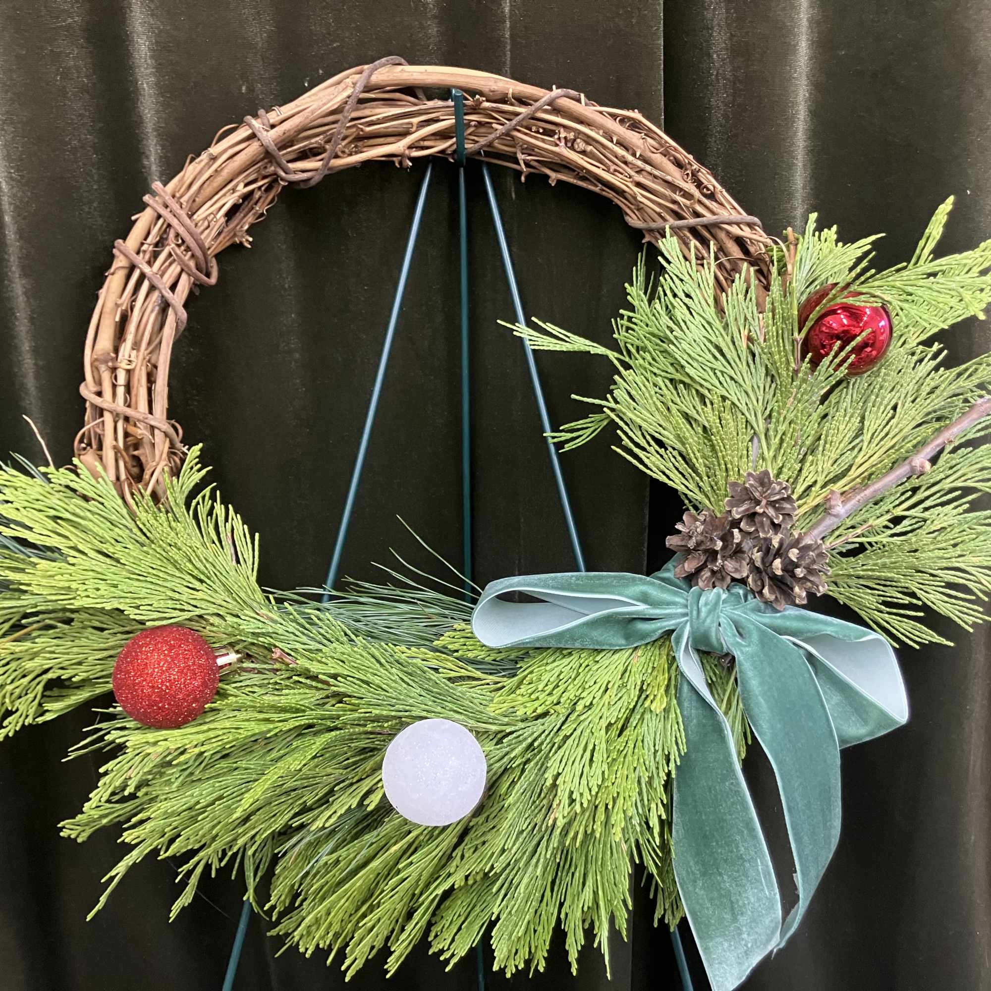 Stay inside where it&rsquo;s warm and create a cute grapevine evergreen wreath!