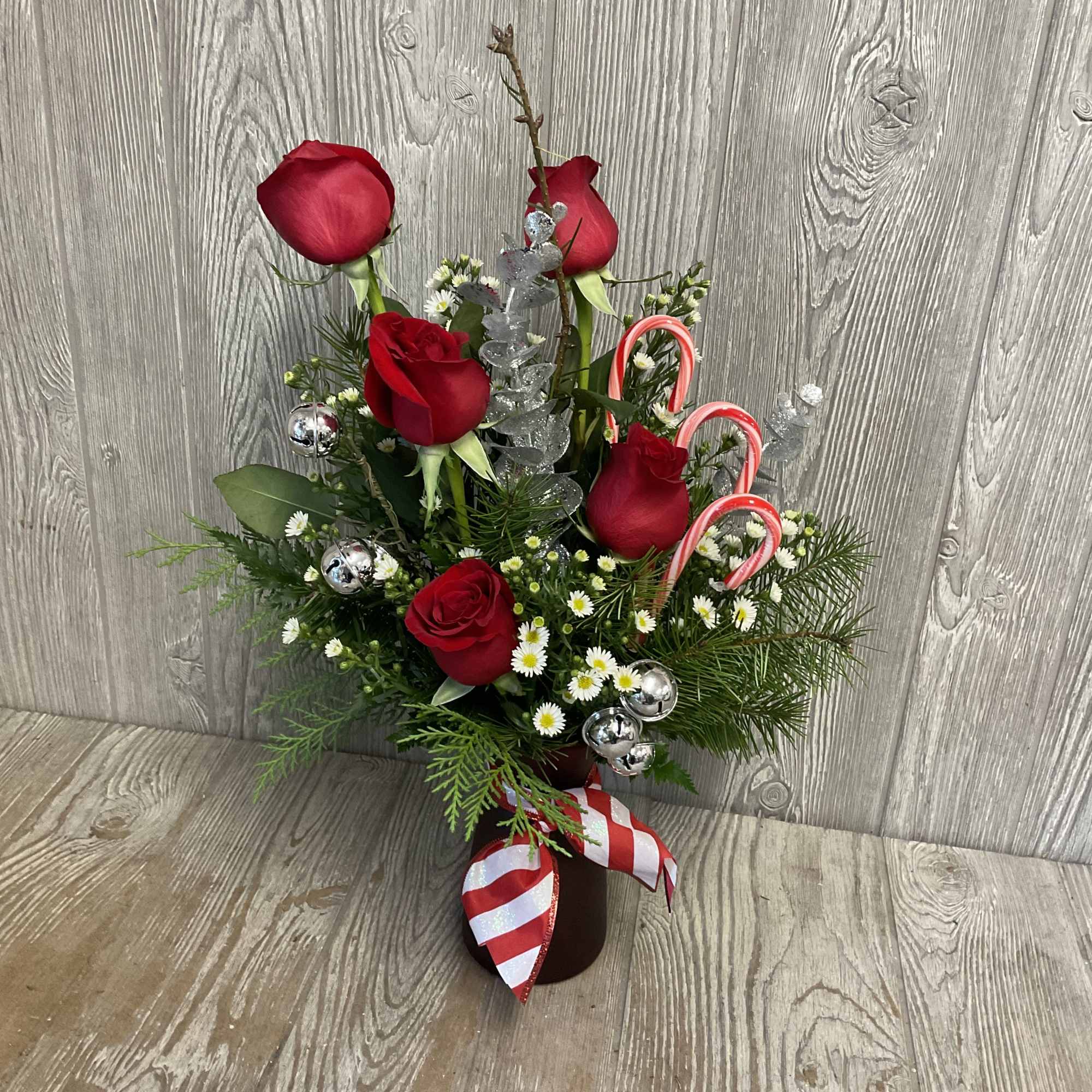 Take a stroll down Candy Cane Lane. Red roses with a peppermint